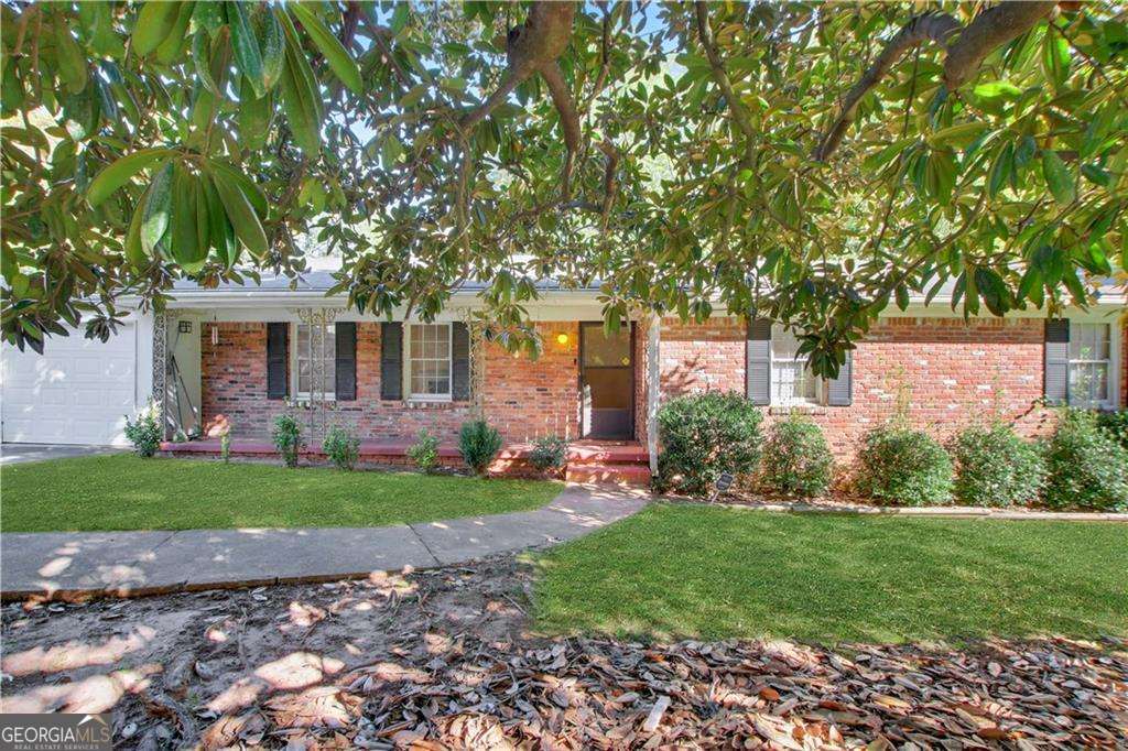 Magnolia Haven: A Renovator's Dream Under the Blossoms. Unlock the potential of this remarkable property - whether you're dreaming of creating your ideal home, planning a renovation to flip for profit, or looking to generate impressive rental income, the opportunities here are endless! This promising home, featuring a unique magnolia tree that stands as the sole specimen of its kind in the neighborhood, boasts a highly sought-after floor plan. The floorplan features three generous bedrooms, including a serene owner's suite with an ensuite bath, all nestled at the rear of the home for peaceful rest. A corridor gracefully leads you to the front-facing living room, complete with a cozy fireplace, perfect for years of enjoyable and comfortable entertaining. Enhance the living space by removing the wall separating the living room from the den, creating an expansive area with stunning views through floor-to-ceiling sliding glass doors that open to the back deck and overlook the sprawling backyard. The home is enviably positioned on a nearly one-acre lot, offering ample space and privacy. Situated just off a charming cul-de-sac in a beautifully maintained community, this home enjoys a prime location. It's conveniently close to Interstate 75 for easy city access and near essential amenities like Walmart Supercenter and Home Depot. Don't miss out on this incredible opportunity to make your real estate dreams come true! RV parked on the front parking pad is available as part of the sale for +$10,000.