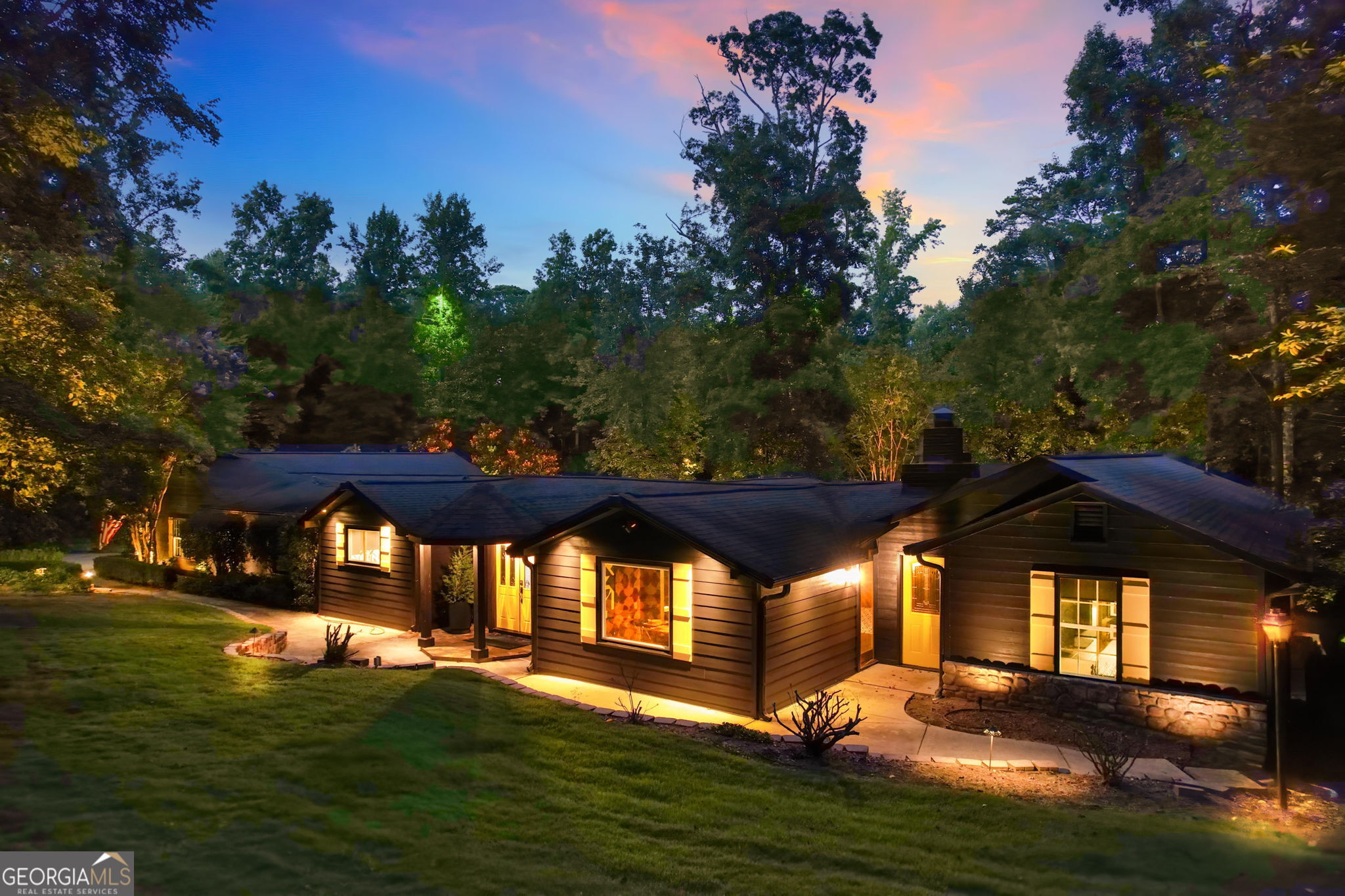 Experience upscale lakeside living on Lake Allatoona in this meticulously renovated and thoughtfully curated ranch estate, complete with deep water access and your own two-slip, two-story boat dock featuring Ipe wood decking and panoramic lake views. Positioned on 1.26 acres, this nearly 5,000-square-foot residence offers a refined blend of luxury design, functional layout, and year-round resort-style living. The home features six bedrooms, four bathrooms, and three bonus rooms, including a spacious flex room off the kitchen ideal for a home office, playroom, or game room. The primary suite on the main level is a true sanctuary, showcasing grasscloth wallpaper, a designer chandelier, spa-inspired en suite bath, and a generous walk-in closet. Below the suite, a private lower level adds even more space, featuring a custom dressing room with built-ins for hats, handbags, and shoes, plus a separate room ideal for a private office, home gym, or wellness space. A second basement on the opposite wing of the home functions as the sixth bedroom, perfect as a media room, guest suite, or private retreat. The interior has been elevated with all-new engineered hardwood floors, a bold charcoal color palette, and a fully renovated chef's kitchen with stainless steel appliances, water-cut marble backsplash, and custom cabinetry. A stylish mudroom with built-ins and a beverage center adds functionality, while Visual Comfort and Regina Andrew lighting, along with Buster + Punch light switches and outlets, deliver unmatched designer detail throughout. The home also includes climate-controlled attic and garage spaces, with the oversized four-car garage offering ample room for vehicles, toys, and storage. A golf cart and hot tub are included in the sale for the ultimate lake life convenience. Outside, the spacious deck, in-ground pool, flagstone patio, and large fire pit create the perfect environment for entertaining or relaxing. The yard is professionally landscaped, fully irrigated, and enhanced with landscape lighting. Furniture is available for purchase, and the boat is negotiable as well, offering a rare opportunity to move into a fully turnkey lakefront estate. With no HOA (VCCI is a civic club with optional membership), this is a truly one-of-a-kind property that combines luxury finishes, thoughtful upgrades, and effortless access to Lake Allatoona.
