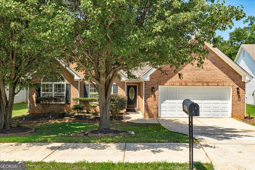 Welcome to this charming single-story home that blends comfort and style, featuring 3 bedrooms and 2 bathrooms. Perfect for families or those who love to entertain, the property includes a spacious 2-car garage and a driveway for extra parking. Inside, you'll find a welcoming open floor plan enhanced by fresh paint and new laminate flooring. The living area offers a cozy fireplace, and just outside, a private back patio awaits, leading to a large, fenced backyard ideal for outdoor activities and relaxation. The kitchen is modern and inviting, featuring sleek stainless steel appliances, complemented by cream-colored cabinetry and new butcher-block countertops. Ample storage and counter space ensure functionality without sacrificing style. The main-level master bedroom offers a large walk-in closet, a separate shower, a soaking tub, and dual vanities. The additional two bedrooms, each with large closets, share a full bathroom. The home's location provides a wonderful balance of convenience and tranquility, with access to a private walking trail and a good school district. You'll also appreciate being just 5 minutes from I-75 exit 212 and the Tanger Outlet. Don't miss the chance to make this delightful home yours! Please schedule your showing today to experience all that it has to offer. Investor Owned, No HOA