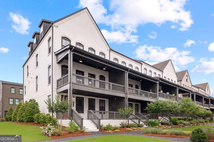 Welcome home to this stunning end-unit townhome located in the highly sought-after Halcyon community in Alpharetta, GA. Just a few years new, this 4-bedroom, 3.5-bath residence offers the perfect blend of modern luxury and convenience. This 22 foot wide floorplan is spacious and open. Ideally situated near the community pool and easy access to the Big Creek Greenway (a 45s walk from your doorstep), making it walking distance to Halcyon's premier shopping, dining, and entertainment. Enjoy views of the beautifully landscaped courtyard from the spacious front porch. Inside, the entry-level foyer welcomes you with a bright and open layout that includes a versatile bedroom, office, or flex space with a full bath, and access to the attached two-car garage with storage space and a private driveway with ample parking. Upstairs, the main living level is filled with natural light and features an open-concept floor plan. The chef's kitchen is equipped with stainless steel appliances, quartz countertops, a large island with seating, and an expansive dining area perfect for gatherings. The fireside family room opens to a generous covered deck, ideal for entertaining. This level also includes a half bath, a dry bar, a large walk-in pantry, and a built-in business/flex center. On the top floor, you'll find a luxurious primary suite with a trey ceiling, a spa-like bath with dual vanities, and a tiled frameless shower. Two additional secondary bedrooms, a full bath, and a convenient hallway laundry area complete this level. An elevator shaft is already installed for future elevator access if desired. Community amenities include a pool, clubhouse, expansive green spaces, and a large shared courtyard-all with direct access to the Big Creek Greenway. Enjoy Forsyth County taxes with an Alpharetta address. This home is a rare opportunity in one of Alpharetta's most vibrant and walkable communities.