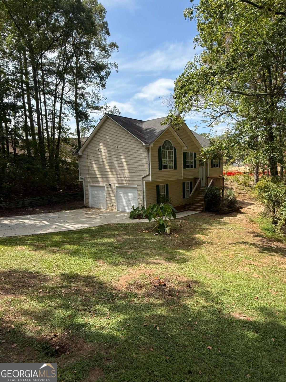 Located in the desirable Eagles Crest neighborhood just off I-675, this stunning home offers a private setting and is truly move-in ready. Inside, you'll love the spacious 4-bedroom, 2-bath layout, perfect for families or anyone needing extra space. The kitchen is a chef's dream with granite countertops, stainless steel appliances, and ample cabinet space. The main living areas feature beautiful hardwood floors, while bedrooms are finished with plush carpet for comfort. A gorgeous fireplace with ornate woodwork and built-in mirror serves as the focal point of the living room. The lower level includes a massive guest suite or media room with a cathedral ceiling and ceramic tile flooring, plus an additional unfinished room ideal for an office, gym, or storage. Throughout the home, vaulted and cathedral ceilings create an open and airy feel you'll love. Don't miss this opportunity to own a home that combines elegance, space, and privacy in a fantastic location!