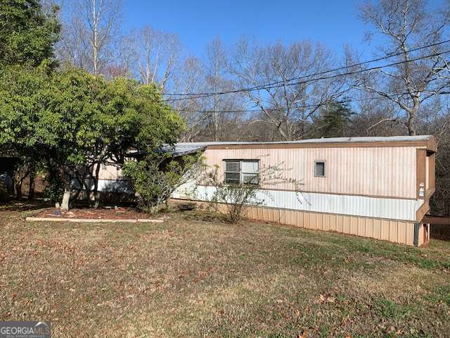 This is a 2 bedroom 2 bathroom property settled in the foothills of Dahlonega, Georgia. The downtown center and schools are a short drive away. Open concept living at its best. Spacious master with accommodating ensuite bathroom. Back deck with mountain views for outdoor living. Room to roam in the lovely front yard. Large windows bring in plenty of natural light. Clean and bright kitchen outfitted with stained wood cabinets, gas range, and fridge. Has multiple storage sheds on property that are part of the rental.