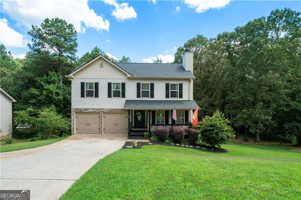 Located just minutes from Allatoona Lake, I-75, and shopping, this beautiful two-story home offers the perfect blend of comfort and convenience. Inside, you'll find a charming breakfast kitchen and a cozy family room featuring a stone fireplace. The spacious master bedroom boasts a large walk-in closet and a bath complete with a double vanity, separate tub, and shower-perfect for unwinding in style. Generously sized secondary bedrooms provide plenty of space for family or guests. Major upgrades include a $15,000 30 yr roof (only 2 years old), a brand-new HVAC system with a lifetime warranty on parts and labor, and a smart water heater for added efficiency. Step outside to a new deck overlooking a huge, level backyard-ideal for entertaining or simply enjoying the outdoors, Reduced thousands for fast sell!!
