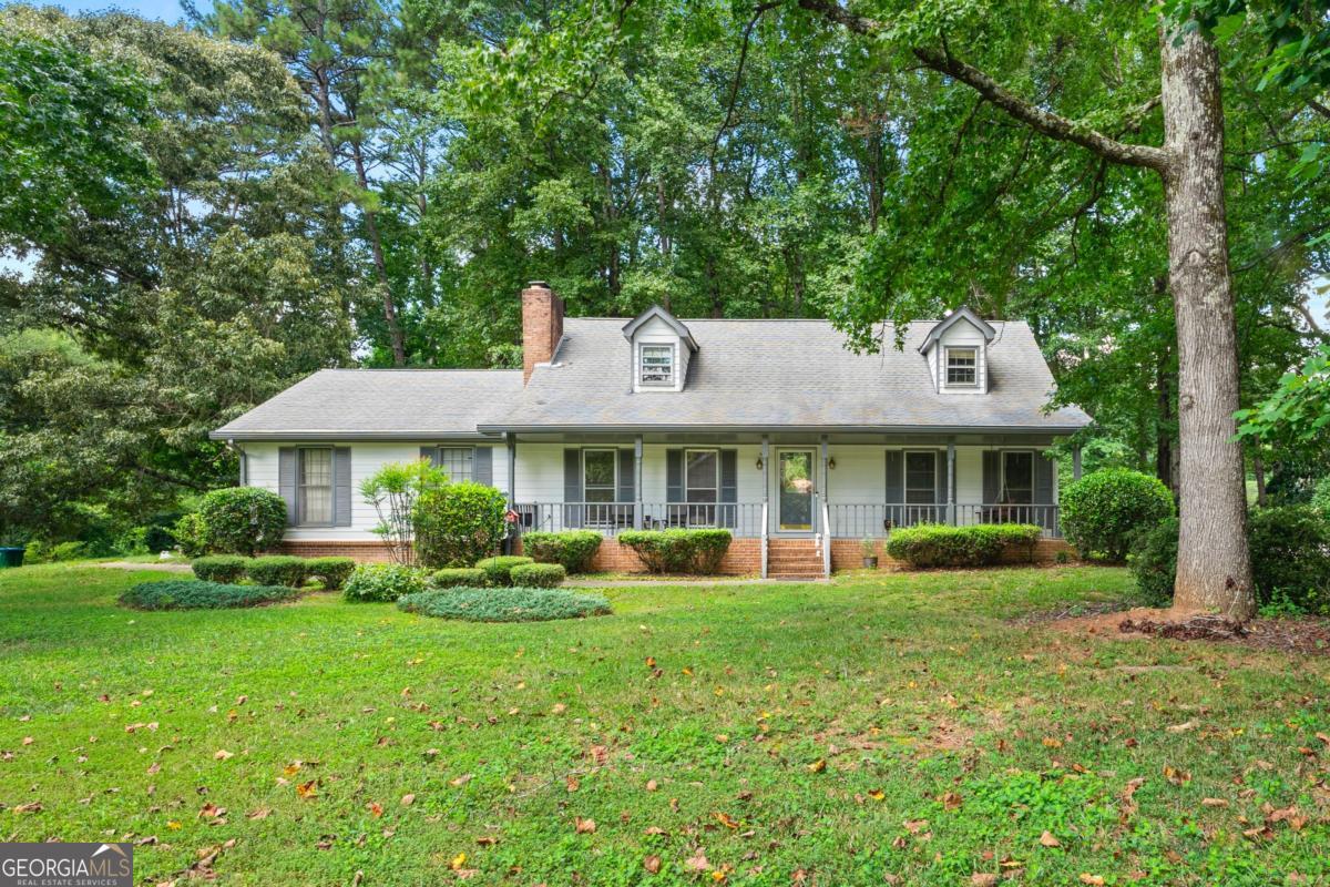Welcome to 4665 Redspruce Drive SW a timeless 3-bedroom, 2.5-bath home nestled on a spacious, wooded lot in the heart of Lilburn. Located in the award-winning Parkview High School district, this well-maintained residence blends classic Southern charm with everyday functionality. Step inside to a warm and inviting living room filled with natural light, featuring a brick fireplace and ample space for gatherings. The separate dining room offers a traditional touch, ideal for hosting family dinners or holiday celebrations. The bright kitchen includes plenty of cabinet storage and a cozy breakfast nook. The oversized owner's suite on the main level includes generous closet space and a private bath. Upstairs, two additional bedrooms offer flexibility for guests, a home office, or growing families. Out back, enjoy the serenity of the large fenced yard and wooded backdrop from the comfort of your private deck perfect for morning coffee or evening entertaining. Additional highlights include a rocking chair front porch and a quiet, well-established neighborhood with no HOA. Conveniently located near shopping, parks, dining, and major highways, this home offers the perfect blend of comfort and convenience.