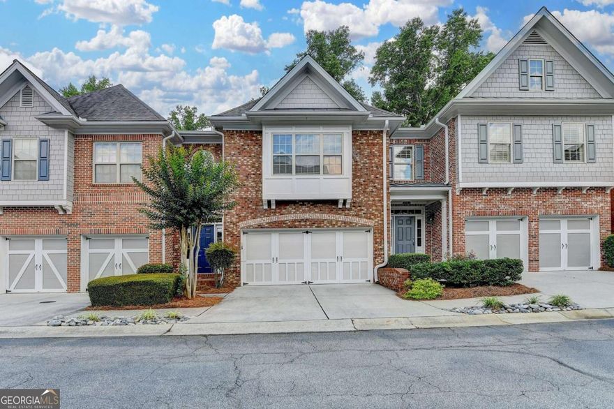 This townhome almost feels like a single-family house, featuring a spacious, fully finished basement and large bedrooms.  This fabulous, family-friendly home is situated in a popular gated swim community, showcasing stunning moldings, intricate details, and high-end finishes. It is nicely upgraded, well-maintained, bright, and open, with vaulted ceilings adding to the airy feel.  The home boasts 4 bedrooms, 3.5 bathrooms, a 4-sided brick exterior, and hardwood floors throughout the main level. The finished terrace level includes a full kitchen, full bathroom, bedroom, and media room-perfect for extra space or entertaining.  The gourmet kitchen features granite countertops and stained maple cabinets, while the spacious master suite includes a beautifully tiled shower and Jacuzzi tub.  Located in the top-rated Johns Creek school district, this home is also conveniently close to shopping malls, restaurants, and parks.