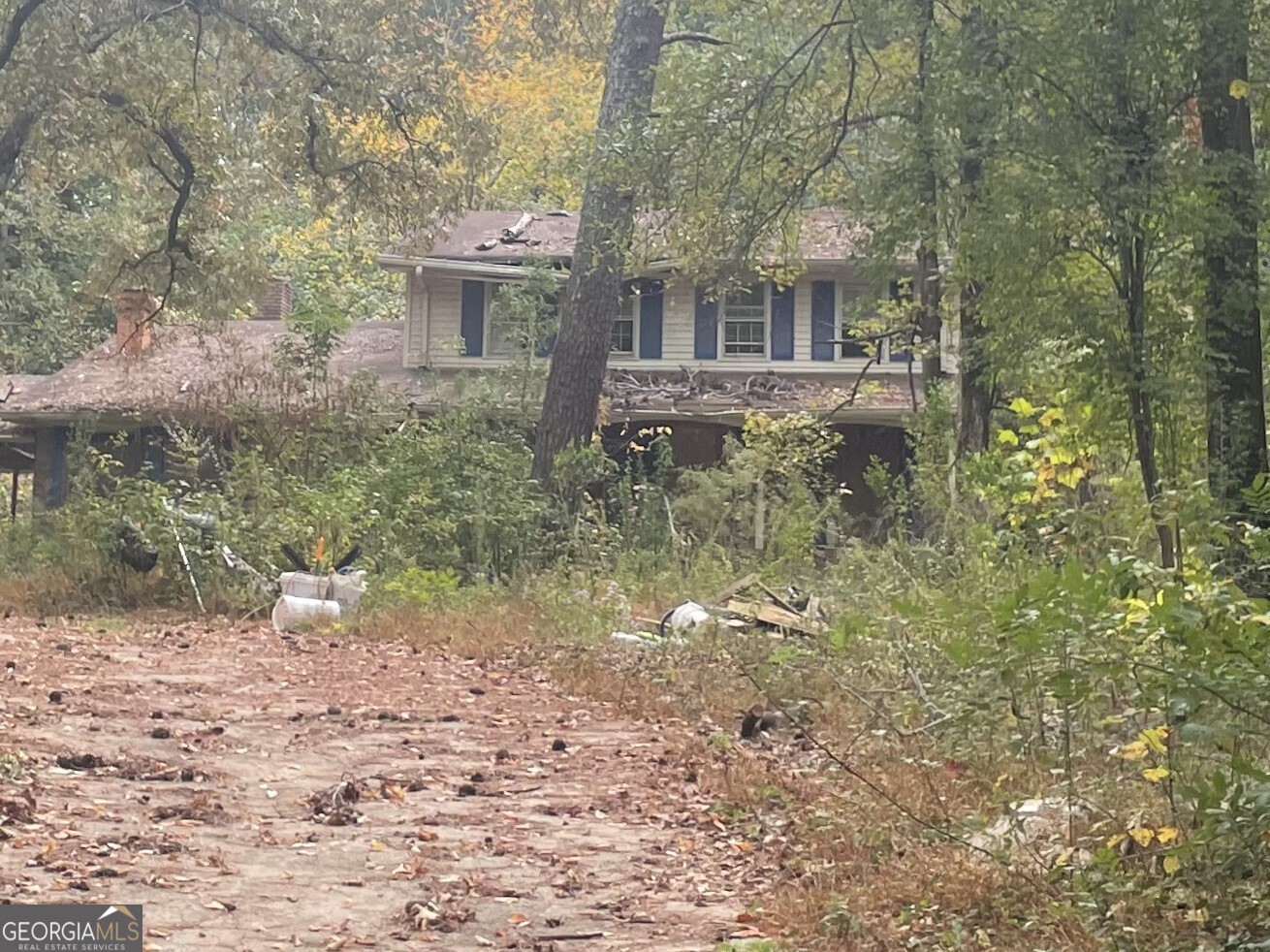 Urban Homestead on5.5- Five and 1/2 ACRES. Private, secluded land with two story house. House needs major renovations or build new. Sold AS IS. Family compound or in-town farming opportunity.