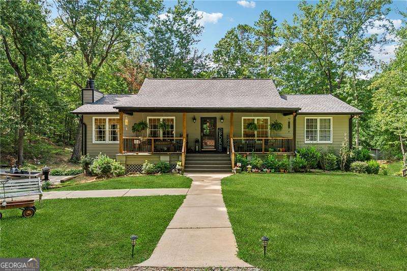 Don't miss out on this beautifully done raised ranch that has been so loved by one owner. It's time for this 6.43 acres to be home to a new family that will love it as much as the Seller's family has! The 3 bedroom, 2 bath home sits on a daylight unfinished basement so there is room to grow if you need additional bedrooms or flex space. The first thing you'll see upon entering is the large stately great room with floor to ceiling wooden bookshelves flanking a gorgeous stone fireplace. Find the floorplan in the images and you can see the separate dining room just off the great room so you can enjoy the fireplace while you have dinner. An eat in, country kitchen connects to the dinning room and also leads out to the expansive multi-tier deck that overlooks the absolute DREAM of a backyard complete with a pond, dock, stalled building, garden and an adorable outbuilding that can be a playhouse for the kids or space for your chickens. The Seller once had horses here so plenty of room for that if your horses need a home too. The 2 car garage is currently open to the basement so if you have boats, jet skis, etc you would have space to pull them in and still have room for your vehicle. Being just a short trek to Allatoona lake who wants to pay extra to store when you have this space already?? If you begin at the road you'll notice two graveled entrances to the property that connect via a wrap around drive. Pulling boats, campers, etc are a breeze with the in and out drive. Each of the driveways serves the one home but if a second homesite is in the plan you can utilize the second drive and road frontage to build another home , barn, etc. Currently the property is using public water but was once on a well so the possibility remains for the next owner to have a well. Can't beat the location with an approximate 10 miles west to I-75 and 10 miles east to I-575. Shopping close in both Canton and Cartersville with easy access to boat ramps and campgrounds on Allatoona Lake. The up and coming City of Emerson is a few exits away and you can be at a Braves game in close to 30 minutes. Come see this property where suburbia meets the country!