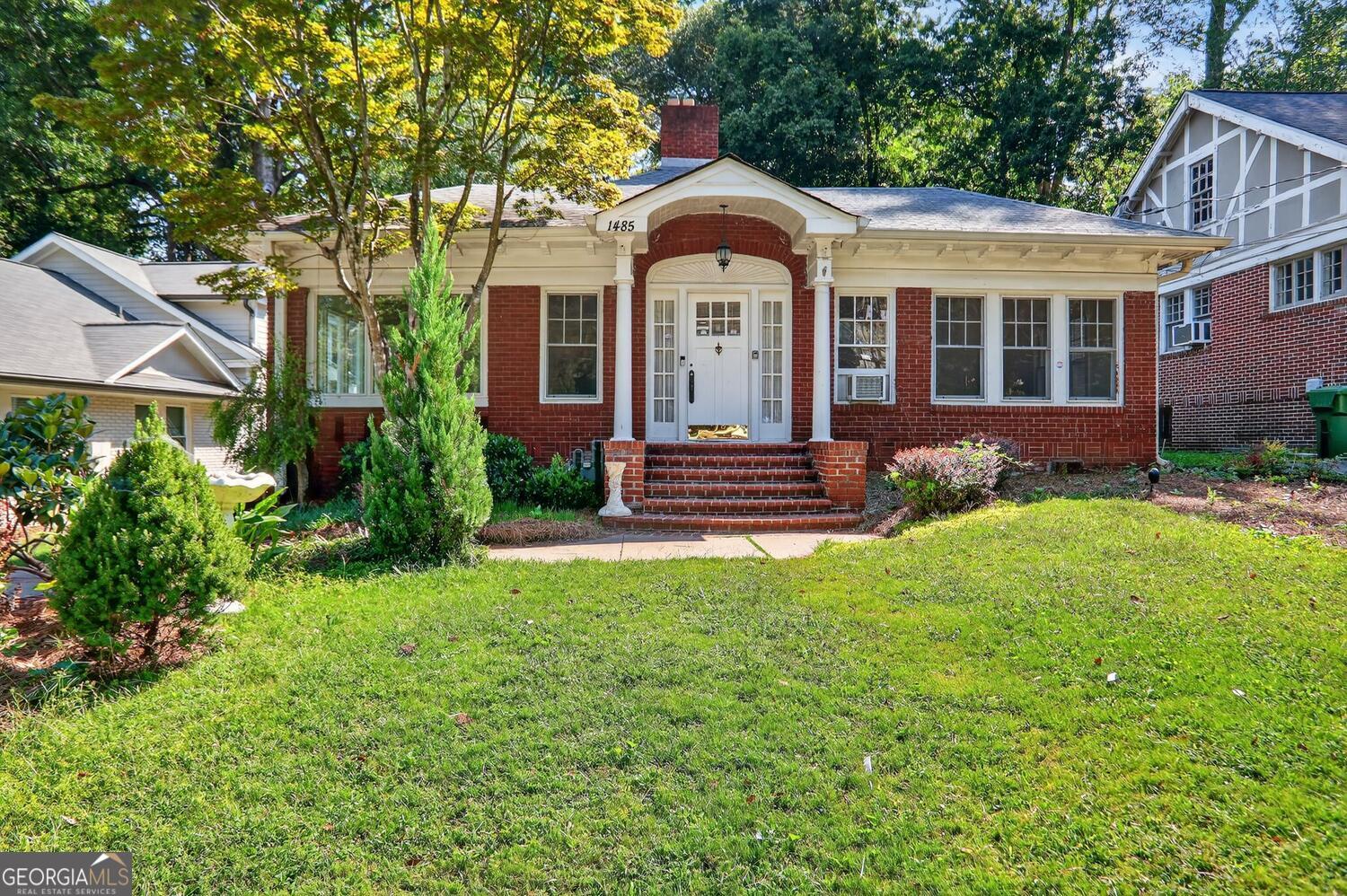 Quarter-Acre Craftsman Bungalow with Character, Space & Endless Possibility Nestled on one of Morningside's most beloved tree-lined streets, this classic 1928 red-brick Craftsman bungalow sits on a rare quarter-acre lot with a deep backyard and gentle slope-offering charm, flexibility, and future potential for both end-users and builders. From the welcoming front stoop and original architectural details to the spacious footprint and mature landscaping, this home is filled with timeless character. Inside, you'll find a formal living room with a beautifully mantled fireplace as the centerpiece of the room, a bright sunroom perfect for a home office or reading nook, and a versatile sitting room that can function as a third bedroom or secondary workspace. A formal dining room connects to a functional kitchen with stainless steel gas range and microwave, and a dedicated laundry room. At the rear of the home, a large family room with oversized windows overlooks the backyard, bringing in tons of natural light. A spiral staircase leads up to a finished loft and attic storage space, adding even more versatility. The primary suite, tucked at the back of the home, features multiple closets and a private bath with dual vanities, an original claw-foot soaking tub, and a separate shower. Off the family room is a deck with stairs that lead down to the deep backyard, where you'll find a small lawn-equipment carport and a shed for additional storage. A wide front yard and a deep, gently sloped backyard make this property perfect for those looking to enjoy it as-is, renovate, or build new. The lot size and layout offer incredible flexibility-making it an ideal candidate for thoughtful expansion or a ground-up custom build in one of Atlanta's most sought-after neighborhoods. Just steps from the dining at Morningside Village, Alon's Bakery, Orme Park, and minutes from Virginia Highland and the BeltLine, this is a rare opportunity to own a piece of intown Atlanta with both historic charm and development upside.
