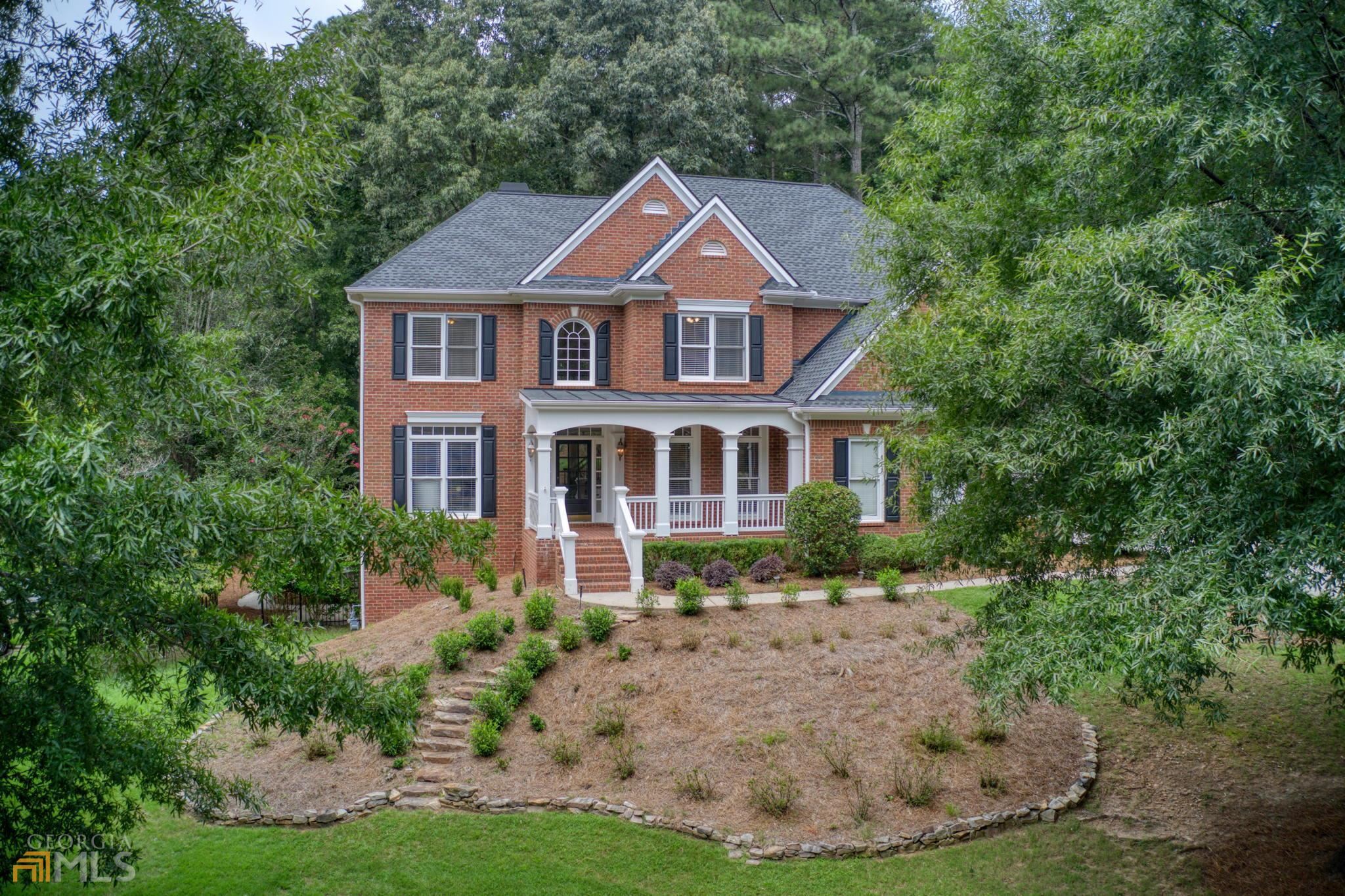 Beautiful Move in Ready home on almost an acre WALKING DISTANCE to AMENITIES in popular swim / tennis community - rocking chair front porch, rear and side patios. ROOF & HVAC about 2 YEARS OLD. FRESHLY PAINTED ON ALL 3 LEVELS. BRAND NEW QUARTZ COUNTERTOPS & NEW SUBWAY TILE. Gorgeous views of park like wooded, fenced back yard with lots of natural light from the floor to ceiling windows. 3 SIDE BRICK on finished basement w/ side entry garage. Walk out to the yard from the main level w/ no stairs! Great floor plan has a home office / bedroom with full bath on main. Master suite with separate office/bonus room & 3 secondary bedrooms (1 ensuite bath & and one Jack & Jill) upstairs. Hardwoods throughout on main. Updated iron spindles w/ hardwoods treads on stairs. Full finished basement has bedroom, full bath, kitchenette, home gym (or multi purpose room) & separate side entrance. Roof has transferrable warranty to new owner. Lots of outdoor space & firepit area. Top Schools, close to Shopping & FABULOUS AMENITIES including: jr Olympic pool (soon to be renovated this year - artist renderings available!), kiddie pool, fenced playground, 6 lighted tennis courts w/ pavilions, sports complex (baseball, soccer, sand volleyball), 2 fishing lakes (canoes, kayak & paddle boats) & miles of walking trails located privately within the community in a nature preserve along the Chattahoochee River! *** Seller can accommodate a very short closing! ***