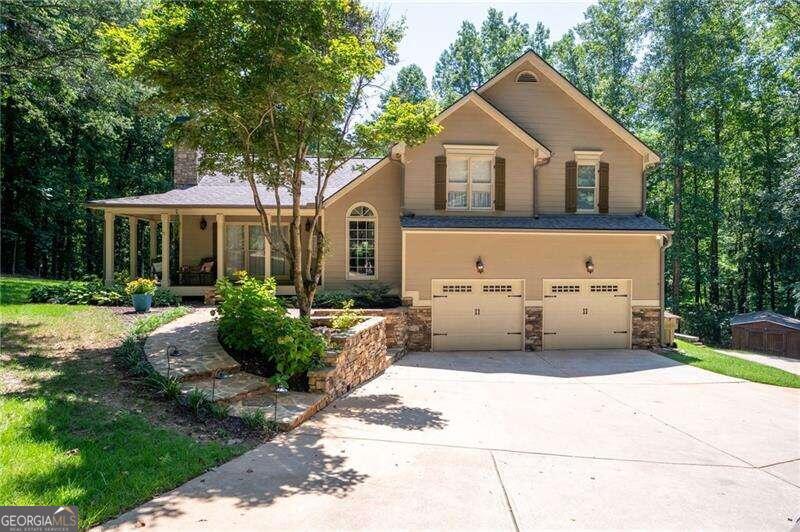 This beautiful property begins with a long driveway leading to 2.2 acres of tranquility and privacy. Next, the impressive and inviting Front porch, wonderful landscaping and stone accents. Main level features entrance foyer, Hardwood flooring, Stacked stone fireplace and is open offering easy flow between living spaces. Large, updated kitchen with granite countertops, recently painted white cabinetry, stainless appliances, breakfast bar easily seating 4+ and brand new tile flooring! Open Dining area easily seats 10! Owners Suite on Main with tile flooring Double vanities and large shower. Dedicated Office and Full size laundry room also on main. Up just a few stairs, the second level offers 3 more spacious bedrooms, one with private bathroom access to the secondary bath offering double vanity and separate tub / shower. Oversized two car garage has (negotiable) lift installed to easily fit 3 cars. Also, a second built-in oven perfect for preparing multiple dishes at once, especially during holidays or gatherings. Basement rec room with stained concrete flooring, sink, cabinetry and storage closet is perfect for family gatherings / playroom but, with its full-size garage door and rear driveway, can be converted back to garage leaving room for storage! Two-tiered rear deck surrounds the above ground pool to enjoy in privacy as you are surrounded by natural greenery and a view of Rakestraw creek!  Outbuilding. Custom built for functionality, style and comfort! Ample parking space. A MUST SEE!