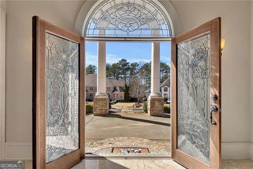 This stunning executive home exudes luxury and elegance from the moment you arrive. The impressive curb appeal features a grand faoade with towering columns and a circular driveway, making a majestic first impression. Nestled on a private lot within an exclusive community, this custom-built masterpiece boasts exquisite details throughout.  Step inside to a breathtaking grand entrance with domed ceilings in the foyer and great room. The great room is a showstopper with a soaring two-story limestone fireplace. The chef's kitchen is a culinary dream, complete with an island, breakfast area, and a cozy keeping room.  The main-level master retreat offers a serene escape with a private sitting area, while all secondary bedrooms are oversized and include private ensuite bathrooms with large walk-in closets. A separate nanny's suite with a private entrance adds even more versatility.  The expansive backyard provides ample space for a pool or outdoor amenities, and the unfinished basement offers endless possibilities - it's large enough to create a full in-law or teen suite and is already plumbed for a bathroom.  The spacious deck and stunning covered patio below provide the perfect setting for entertaining guests or savoring a morning coffee and an evening nightcap in total relaxation.  Spacious three-car garage with plenty of room for Recreational Toys!  Top Rated School Districts.  This exceptional home is a rare find - schedule your private tour today By Appointment Only!