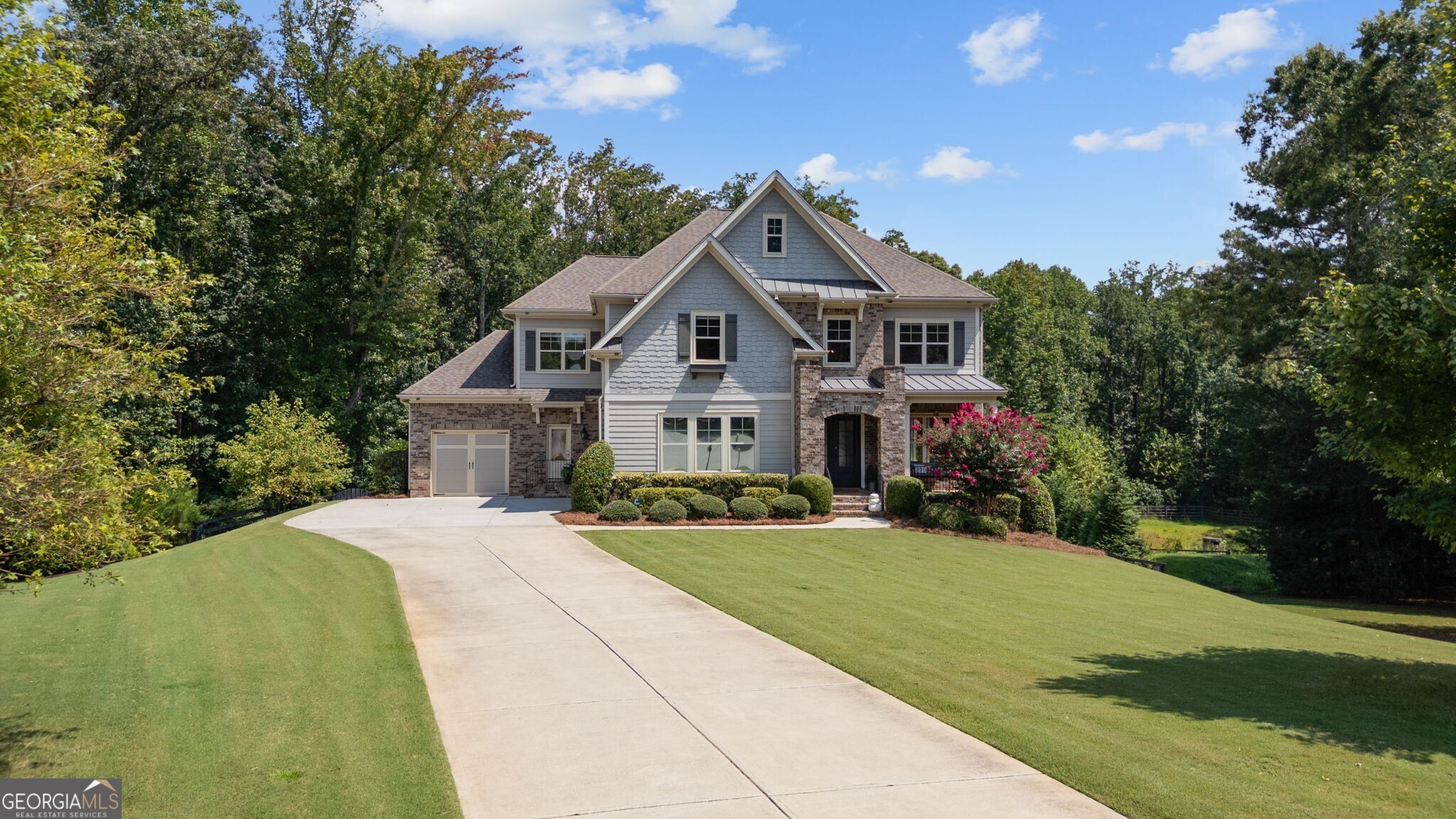 Nestled on a secluded 1.58 acre cul de sac in Milton's Taylor Estates, this thoughtfully designed home offers five bedrooms and 51/2 baths across 4,608 sqft. The main level features an open layout connecting the bright eat in kitchen-with walk in pantry and stone counters-to the dining area and two story great room that opens to a composite deck and expansive backyard. A private guest bedroom with a private bath and side entry access adds convenience and flexibility. Upstairs, a large bonus area sits alongside the primary suite, laundry room, and three additional bedrooms. The terrace level is custom built for entertaining with a theater room, bunk room, family and billiards areas, fitness room, full bath complete with custom sauna, and access to a covered deck featuring a day bed swing. The outdoor retreat continues with a paver patio leading to a heated, saltwater pool, fire pit, and sports court. Located near award-winning schools, the Crabapple district, downtown Alpharetta, and Avalon, this home is move-in ready and comes with over $50,000 in recent updates to landscaping and flooring, emphasizing both its refined design and outdoor appeal.