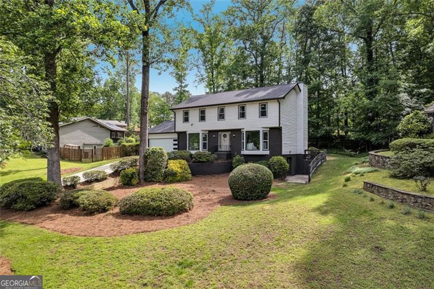 Welcome to this beautifully renovated 4 bed, 3.5 bath home located in the highly sought-after Indian Hills community of Marietta. Situated in the award-winning Wheeler Magnet School district, this home offers modern upgrades, and an unbeatable East Cobb location. Freshly painted inside and out, this home features a brand-new roof, windows, garage door, AC compressor, water heater, slow-close cabinetry, light fixtures, and all-new flooring throughout. The open-concept main level welcomes you with a dramatic black brick fireplace, custom built-ins, and an enclosed sunroom that fills the home with natural light. The chef's kitchen is a true highlight, showcasing crisp white cabinets, new quartz countertops, a stylish tile backsplash, gold hardware, and a sleek black vent hood over a gas range, perfect for everyday living and entertaining. Upstairs, the spacious owner's suite offers a spa-like retreat with a double vanity, frameless glass shower, and walk-in closet with a modern barn door. Secondary bedrooms are freshly updated and share a beautifully renovated hall bath.The fully finished basement expands your living space with a full bathroom, wet bar, and a versatile room ideal for a home office, guest suite, or game room. Outside, enjoy a private backyard with a custom gravel patio and fire pit area, ideal for gatherings or quiet evenings. Move-in ready and upgraded, this home offers timeless design, modern comfort, and convenient access to I-75, East Cobb Avenue, and Historic Marietta Square. Don't miss your chance to make this East Cobb GEM your own!