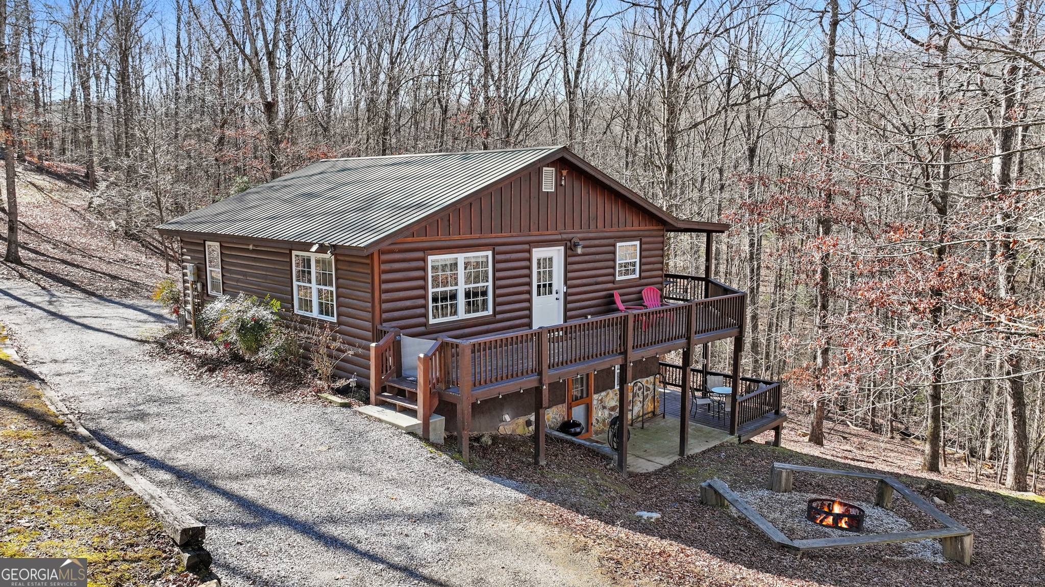 Welcome to your dream mountain retreat-a beautifully crafted 3-bedroom, 2.5-bath cabin nestled in the heart of the North Georgia mountains, just minutes from historic downtown Blue Ridge, GA. Whether you're seeking a lucrative short-term rental investment or a serene personal escape, this home seamlessly blends rustic elegance with modern comfort. Tucked away on Cowboy Way, this charming cabin embodies Western charm and Southern hospitality. The spacious open-concept living area welcomes you with a cozy stone fireplace, and an abundance of natural light. The fully equipped kitchen, complete with quality appliances and ample counter space, is perfect for preparing home-cooked meals after a day of adventure. The primary suite offers a tranquil retreat, while two additional bedrooms provide ample space for family and guests. Step outside onto the expansive decks, where you can soak in the fresh mountain air, sip your morning coffee, or unwind under the stars. The outdoor space is perfect for entertaining, featuring a firepit for roasting marshmallows and plenty of room to take in the scenic surroundings. With its prime location, this cabin places you just moments from Blue Ridge's finest attractions. Explore the quaint downtown shops, farm-to-table dining, award-winning wineries, and the renowned Blue Ridge Scenic Railway. Outdoor enthusiasts will appreciate easy access to hiking trails, waterfalls, Lake Blue Ridge, and world-class trout fishing. Whether you envision cozy weekends by the fire or a high-performing turnkey STR investment, this cabin offers the best of Blue Ridge living. Don't miss your chance to own a piece of mountain paradise-schedule your showing today!