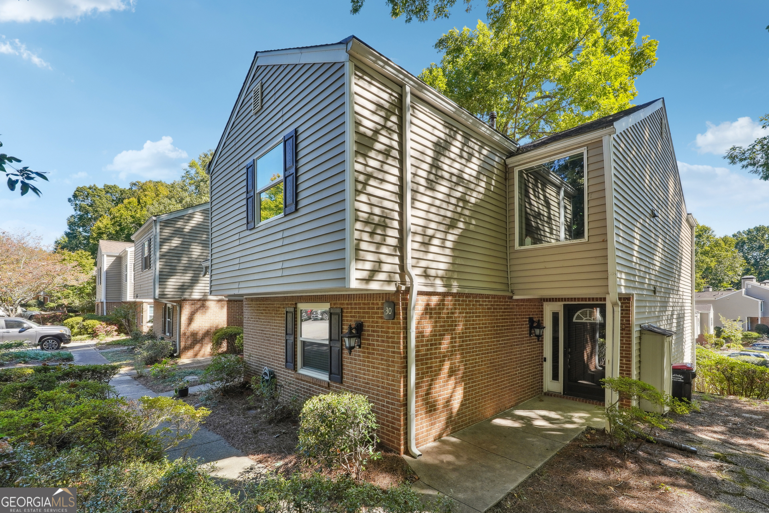 Discover Urban Elegance step-free ground level unit in Dunwoody Springs! Welcome to your spacious 1,900-square-foot end-unit town-home nestled in the peaceful Arbor of Dunwoody Springs. This private enclave offers resort-style living in the heart of The Perimeter Center and Dunwoody/Sandy Springs area. The thoughtfully designed roommate-style floor plan features BRAND NEW LVP flooring, oversized bedrooms and abundant closet space. A tiled entry foyer welcomes you into the bright and airy great room, anchored by an inviting gas fireplace. The versatile sun-filled flex space serves perfectly as an office, playroom, reading nook, solarium, or guest retreat. Recent upgrades elevate the living experience with renovated bathrooms, designer light fixtures, and sleek quartz countertops. The kitchen flows seamlessly to a private, courtyard-style patio Co an ideal spot for morning coffee or al fresco dining. Location is everything, and this town-home delivers. Minutes from I-285, Perimeter Mall, fine dining, and premium shopping destinations, you'll enjoy the perfect blend of tranquility and urban convenience. Experience the best of Dunwoody living in this meticulously maintained end-unit. Schedule your viewing today!