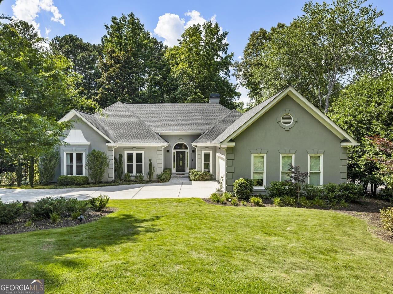 Set against the backdrop of the highly coveted enclave of Lake Windward, this stunning ranch-style home sits on a waterfront lot and offers a unique blend of luxury, privacy, and natural beauty. Perfect for those who love to entertain and enjoy idyllic views from every room, this home boasts multiple outdoor spaces including an oversized deck that provides breathtaking vistas of the water, a covered patio off the lower level, and a large open grassy area ideal for playing games and enjoying the outdoors. The private boat dock affords you direct access to the water for recreation and relaxation to all Lake Windward has to offer! Enjoy your morning coffee on the dock and evening sunset cruises across the lake. The interior of the home maximizes all of these captivating views and allows you to soak up the serene surroundings from nearly every room in the house. The thoughtfully renovated and open kitchen flows into the breakfast room and family room with vaulted ceilings, a stunning fireplace, and expansive floor-to-ceiling picture windows perfectly framing picturesque views of the lake. The main level includes four bedrooms, including the primary suite with a beautifully renovated bathroom with heated floors and an oversized frameless shower. The terrace level offers an entire additional living space with a full bedroom, full bathroom, and two large versatile rooms for various lifestyles - if you need multigenerational living or more recreation space, it can accommodate your needs. Located in the heart of Alpharetta with direct access to Lake Windward amenities, including the pool, tennis courts and pathways around the corner from the home, as well as Alpharetta Greenway trail, residents can enjoy all of these amenities and still live within a private neighborhood setting. Enjoy this convenient location just minutes to restaurants in Avalon and downtown Alpharetta and close by to schools just outside the community, including Lake Windward Elementary, Webb Bridge Middle and Alpharetta High schools. All of these beautiful interior and exterior features as well as amazing location make this property a truly exceptional find.