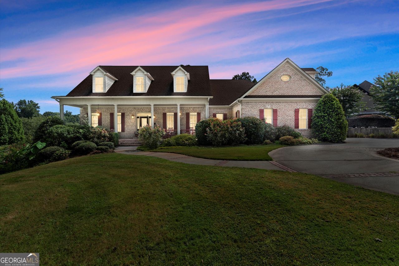 Welcome to lakeside living at its finest in this expansive retreat boasting over 6,000 total finished sq. ft. home, perfectly situated on a 1.65-acre big-water lot in the coveted Lake Walton Estates community. With breathtaking panoramic lake views, multiple outdoor living spaces, and a layout designed for flexibility, this home delivers a rare opportunity to own your own slice of paradise. Inside, natural light pours into the open, airy floor plan where spacious living and dining areas seamlessly blend for both everyday comfort and entertaining. The kitchen features double ovens, ample storage, and endless potential to customize your dream culinary space. The main-level primary suite is a true retreat offering sweeping lake views, a spa-inspired bath, and private deck access. Upstairs, you'll find two generous bedrooms and a loft ideal for family, guests, or office space. The 2,403 sq. ft. fully finished terrace level is a showstopper, complete with a second full kitchen, a media room, a gym, and a private guest suite. Plus, there's 452 sq. ft. of unfinished storage ready for your personal touch. Whether you're hosting friends, planning for multi-generational living, or creating the ultimate game-day retreat, this level is designed for it all. Step outside and experience the ultimate in outdoor living. Multiple covered decks and patios overlook lush greenery and a 300+ acre lake, perfect for fishing, kayaking, boating, morning coffee, afternoon barbecues, and sunset cocktails. The 2-car side-entry garage, circle driveway, and beautifully landscaped grounds complete the picture. Located within a gated community with swim, tennis, clubhouse, and a community dock for lake access, this home blends luxury living with a relaxed, resort-style atmosphere. HIGHLIGHTS: Covington address-Walton County schools; 300+ acre lakefront; Fishing, kayaking, boating, swim, tennis, clubhouse, and community dock