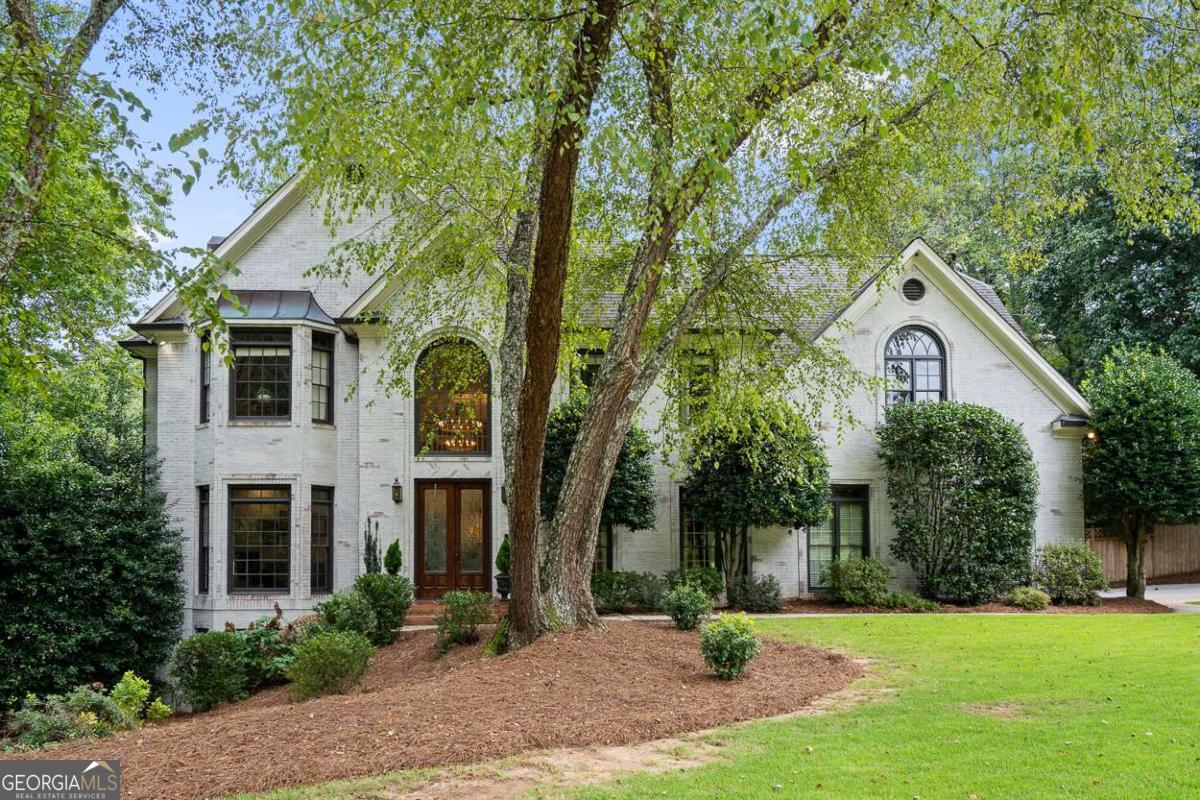 An absolute stunner in the desirable Old Paper Mill neighborhood! This beautifully renovated home offers over 6,000 square feet of living space and is located within the prestigious Cobb County school district, including the renowned Sope Creek and Wheeler schools. Step inside to discover a spacious, open floor plan flooded with natural light and hardwoods throughout. The newly renovated kitchen is a chef's dream, featuring modern finishes, high-end appliances, and an abundance of storage space. The expansive basement is fully finished, perfect for entertaining, a home theater, or an in-law suite. The luxurious primary bathroom has been thoughtfully redesigned, providing a spa-like retreat. Other updates include a completely remodeled laundry room and beautifully designed wet bar room. This home also boasts a variety of bonus rooms, including a cozy office, a sunroom to enjoy your morning coffee, and a screened-in porch that seamlessly blends indoor and outdoor living. A loft space off one of the bedrooms offers additional flexibility for play or study. Enjoy the convenience of a 2-car garage, plus extra space for a golf cart, making it easy to take advantage of the community's tennis and swimming amenities. This home offers everything you need for comfortable, luxurious living in one of the most sought-after neighborhoods in the area. Don't miss your chance to make it yours!