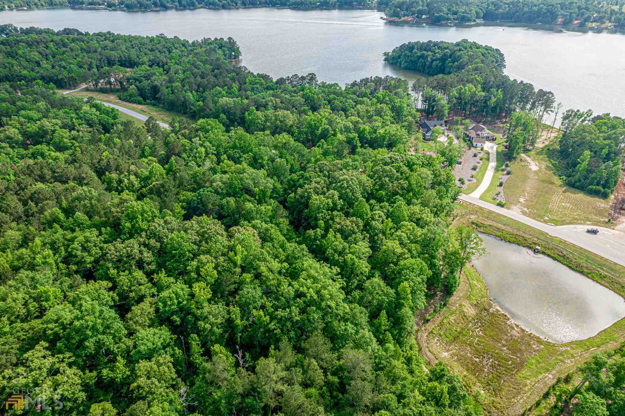 LAKE OCONEE COMMUNITY LOT - located in Morgan County across the street frpm Lake Oconee and the community docks in the gated subdivision of Sailview. Morgan County school district but still close to all the action at Lake Oconee. Wonderful lot for building with perfect location in the community, lots of hardwoods and wonderful setting. Come see for yourself!