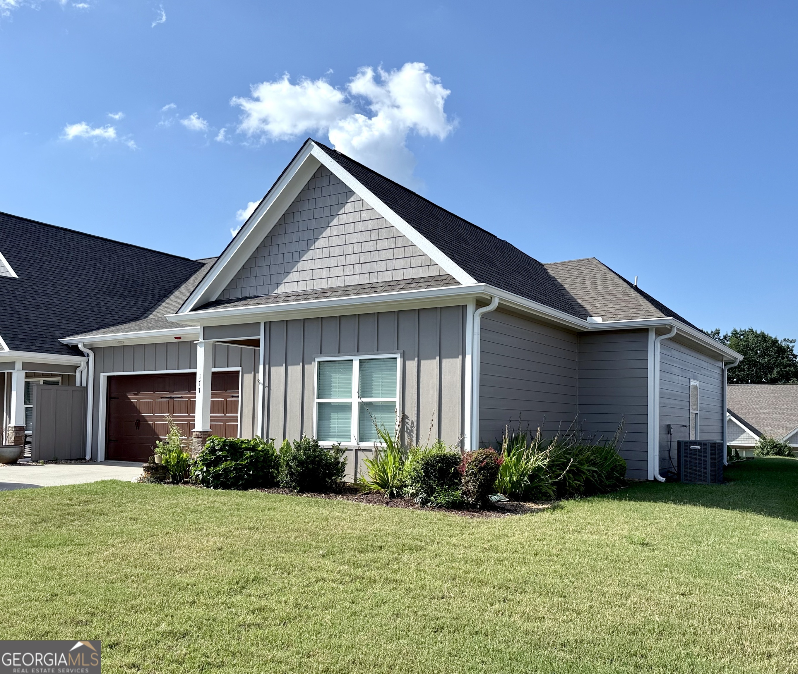 Sought-After End Unit Townhome in Gated Crown Mountain Community! Located within the city limits of Dahlonega, this rare end unit offers stunning mountain views and overlooks the heart of downtown from the top of Crown Mountain - one of the area's most unique and desirable gated communities. Step inside and enjoy a spacious open floor plan perfect for family living or entertaining. The kitchen features granite countertops, a breakfast bar, and ample workspace, flowing seamlessly into the dining area and vaulted family room with cozy gas-log fireplace and gleaming hardwood floors. All three bedrooms and 2.5 baths are located on the main level, including a generously sized master suite. The master bath includes double vanities with granite tops, a soaking tub, and a separate walk-in shower. Additional features include a double garage, a private side patio with mountain views, and low-maintenance living in a peaceful, elevated setting. Enjoy the convenience of in-town living with the serenity of mountain vistas - just minutes from Dahlonega's shops, restaurants, wineries, and UNG campus!