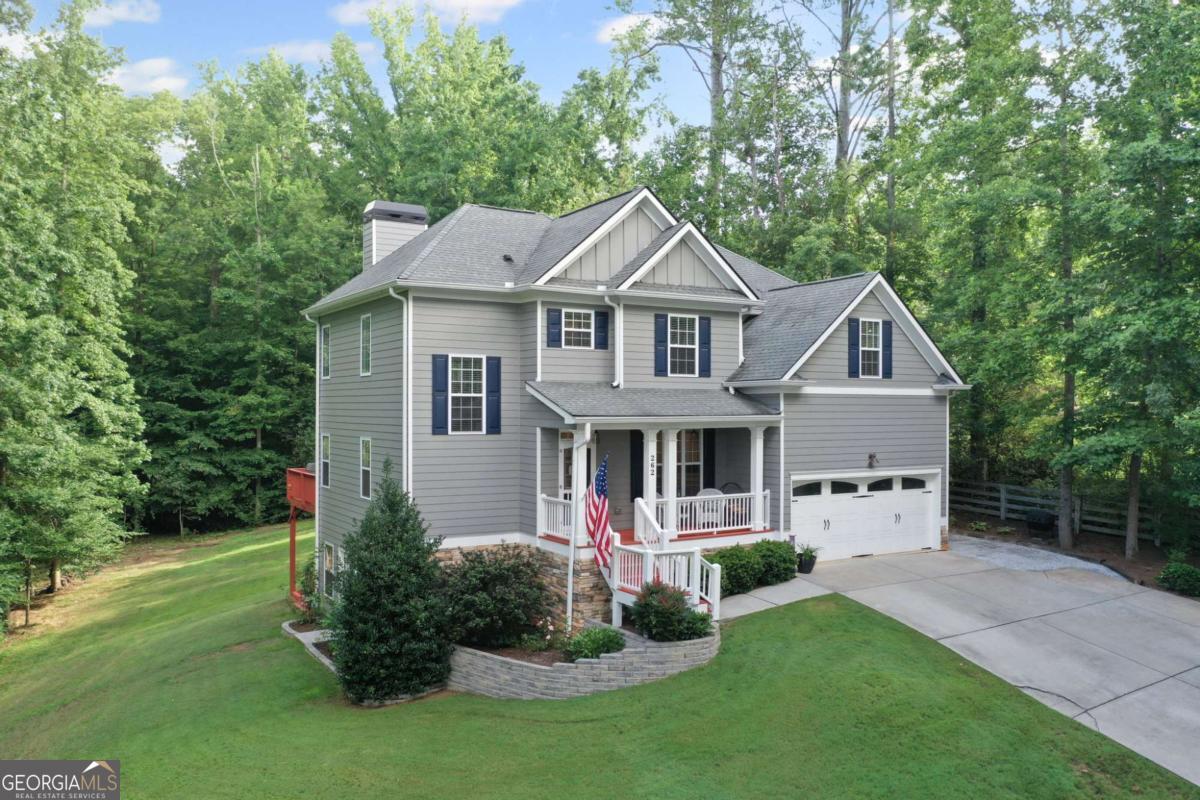 TERRIFIC SLICE OF HEAVEN IN CREEKVIEW/AVERY SCHOOL DISTRICT ON 1.07 AC! NO HOA! This wonderful home is tucked away on a small, quiet street minutes from Canton Marketplace and Northside Cherokee Hospital! A Must-Have Rocking Chair Front Porch welcomes you to this terrific 4BR/3BA home with an unfinished, daylight basement. Lovely Dining Room is perfect for future family gatherings. You're going to love the charming Family Room with Coffered Ceiling and Cozy Fireplace. REAL HARDWOOD FLOORS! Upscale Kitchen with Granite Countertops, Designer Backsplash Tile and SS Appliances. Sunny Breakfast Room open to the Family Room. Convenient Guest Bedroom and Full Bath with Granite Countertops on the main level! Second Floor features an Oversized Raised Recreation Room that could be a terrific media room, playroom, game room, homeschooling room, and so much more. Spacious secondary bedrooms. Upscale secondary full bath with granite countertops. Luxurious Owners Suite with Sitting Room and Spa-like Owners Bath with dual sinks, granite countertops designer tile and separate tub and shower. Large Closet. The owner's sitting room includes built-in cabinetry and doubles as a great home office or craft room! Privacy Galore in the backyard with lovely deck overlooking the yard. Unfinished daylight basement with lots of windows ready for you to finish! You'll certainly appreciate the parking pad for parking a 3rd car, camper, trailer, truck, etc. AMAZING LOCATION close to 575/Peachpass, Downtown Canton Restaurants/Farmers Markets/Activities, etc., North GA wineries, Veterans Park, Canton Marketplace and Northside Cherokee Hospital! CREEKVIEW HS DISTRICT! Don't miss this great opportunity!!