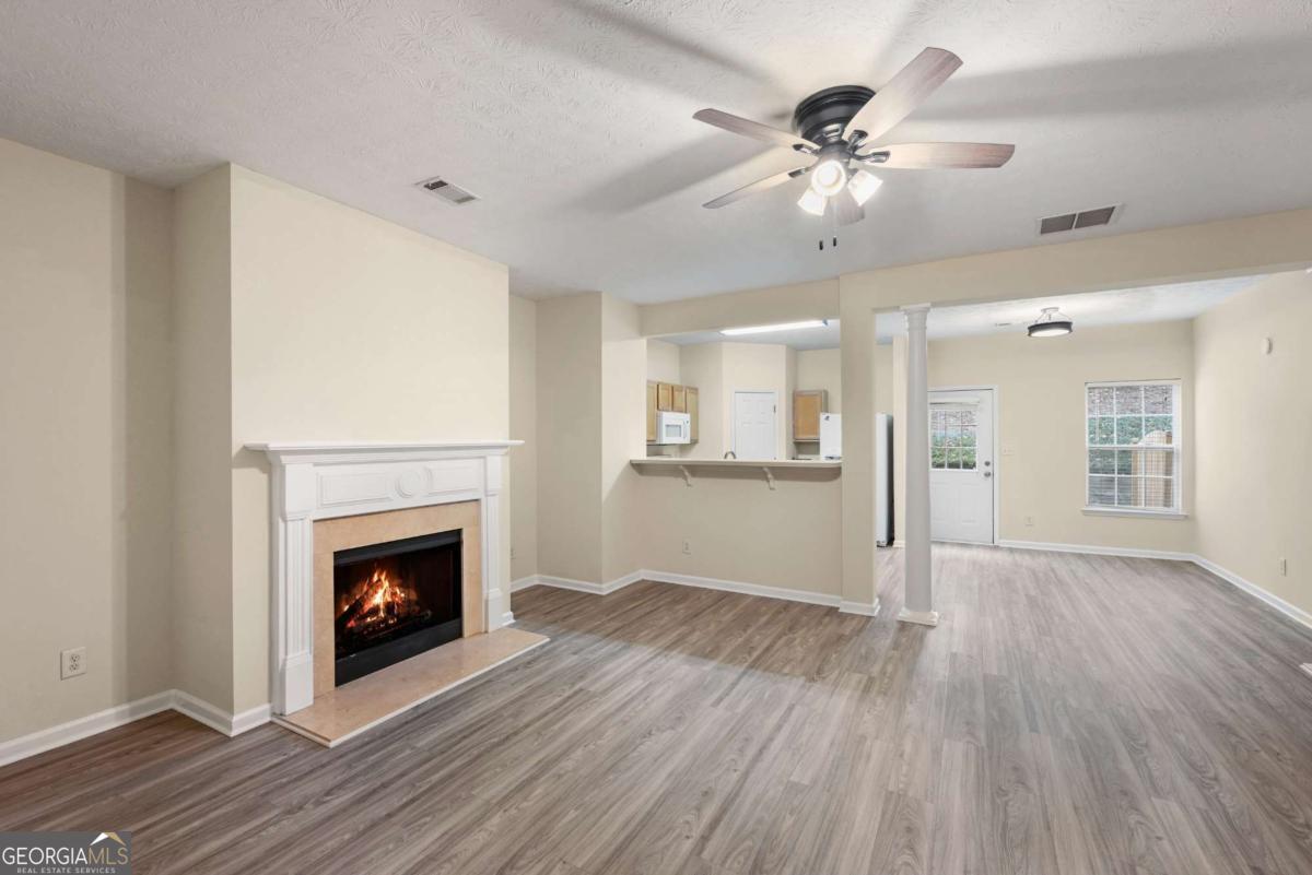 Don't miss this beautifully updated 2-bedroom, 2.5-bath townhome ideally situated with easy access to GA-400, top-rated South Forsyth schools, shopping, dining, and parks. Located directly across from scenic green space, this home offers both convenience and tranquility. The thoughtfully designed double master floor plan features spacious bedrooms with walk-in closets, a relaxing garden tub, and a cozy gas fireplace in the family room. The kitchen boasts a large pantry, along with a brand-new range and microwave. Enjoy fresh updates throughout, including new flooring, new carpet, and fresh paint. Additional highlights include: * Investor-friendly community with no rental restrictions * Low-maintenance living with lawn care and garbage pickup included in the $105/month HOA * Private 1-car garage Whether you're a first-time buyer, investor, or looking to downsize, this home has it all. Schedule your showing today-this one won't last long!