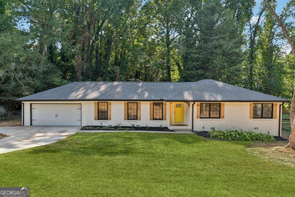 Fully Renovated ranch in prime location! Located in the highly desirable Brookwood School Cluster, this stunning 4-bedroom, 2-bath ranch has been completely transformed with modern upgrades and timeless style. Just minutes from Scenic Highway, you'll enjoy easy access to endless shopping, dining, and entertainment options. Step inside to discover an open-concept layout with brand-new hardwood floors, a sleek quartz waterfall island, and a stylish electric fireplace that creates the perfect centerpiece for gatherings. Both bathrooms have been beautifully renovated, complementing the home's fresh, modern feel. Additional updates include a new A/C unit, new water heater, and fresh interior and exterior paint, ensuring true move-in readiness. This home combines prime location, top-rated schools, and a complete renovation-making it a rare find you don't want to miss!