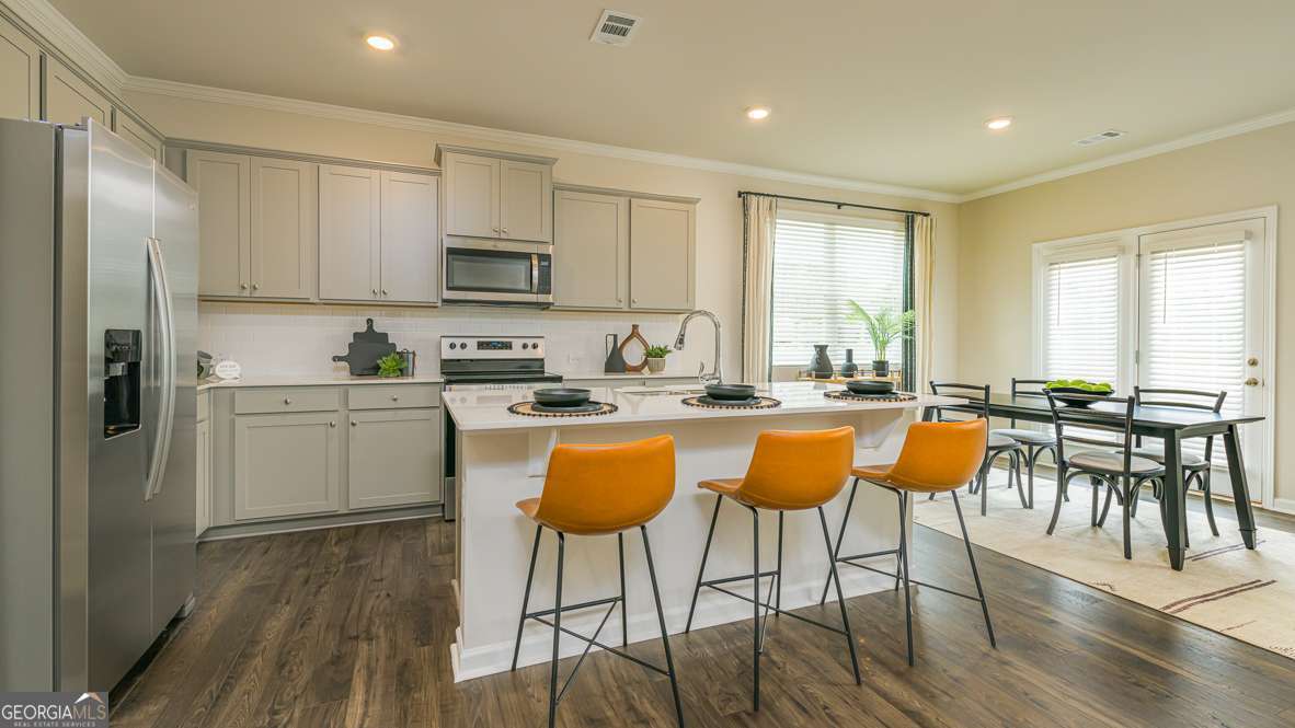 The Salisbury Floor Plan is a newly constructed, two-story townhome designed for modern living. This spacious home features three bedrooms, 2.5 bathrooms, and a two-car garage. The open-concept main floor boasts a stylish kitchen with 42C cabinets, crown molding, a chic tile backsplash, and elegant quartz countertops. The space flows seamlessly into a cozy living area and a dining spaceCoperfect for entertaining. Upstairs, two secondary bedrooms share a convenient Jack-and-Jill bathroom and offer generous walk-in closets. The primary suite serves as a private retreat, complete with an en-suite bath and a spacious walk-in closet. With contemporary finishes, ample storage, and a low-maintenance exterior, this townhome blends comfort and functionality in a prime Barrett Parkway locationCojust minutes from parks, dining, and shopping.