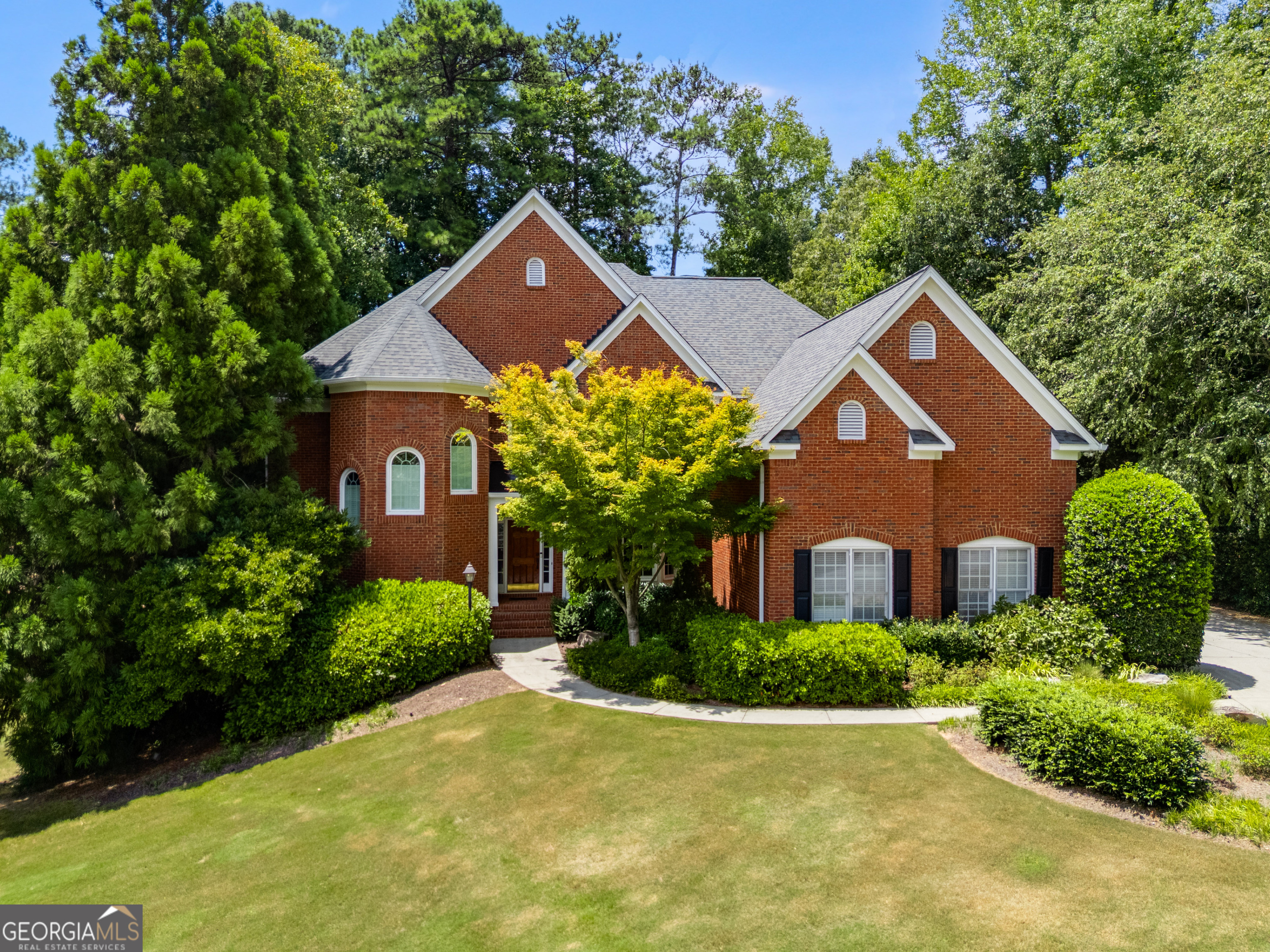 Tucked Away on a Serene Cul-de-Sac you'll find this traditional brick beauty nestled in one of Dunwoody's most sought-after neighborhoods. Welcome to the perfect blend of tradition, luxury and location. This stunner is situated on an oversized completely fenced quiet wooded lot complete with mature magnolias surrounding an inground heated gunite pool and spa. Through the grand foyer, you have an open floor plan with a massive dining room, a soaring living room with fireplace, as well as a private den off the living room. A sunroom is located off this den overlooking the beautiful pool and outdoor entertaining are complete with multi-level deck. Step back inside to discover an updated gourmet kitchen on this level, complete with high-end appliances, custom cabinetry, and sleek countertops-ideal for the home chef. Whether you're cooking for a crowd during the holidays or trying a new recipe for the family, this space is made for being together, connecting, laughing and making memories. A full bedroom and bath on the main floor provide a perfect space for guests, multigenerational living or a private office. Upstairs, you'll find three generously sized secondary bedrooms (one with its own en-suite), plus a lavish primary suite featuring an updated spa-like bathroom you'll never want to leave. The oversized primary closet includes a bonus room perfect for an additional home office, workout space, or additional storage. The fully finished basement is a home in and of itself, complete with separate entrance, a second kitchen, an additional bed and bath, as well as a spacious living area, and room for a home theater, teenage hang out or game room not to mention the unbelievable wealth of unfinished space for storage. Additional features include a spacious 3-car garage plus an extra parking pad - ideal for guests, hobby vehicles, or storage. Enjoy morning coffee or evening relaxation in the beautiful sunroom or step out onto the expansive deck overlooking your private, fenced backyard oasis. Cool off in the sparkling pool (recently having had an extensive facelift so that it's brand new again), entertain under the stars, or simply unwind in the tranquility of your own retreat. All of this in a prime Dunwoody location, with top-rated schools, close proximity to premier shopping, fabulous dining, and an easy commute to anywhere in the city. This beautiful home combines timeless architecture with luxurious updates and thoughtful design, perfect for both everyday living and exceptional entertaining.