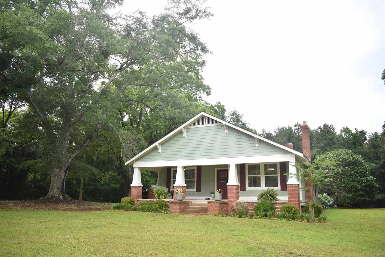 Beautiful Craftsman Style home sitting on 2+/- acres. This 3 bedroom, 2 bathroom home has many features to fall in love with! Large front porch, open floor plan with large kitchen island, stainless appliances, mud room and separate laundry room, 3 decorative fireplaces, hardwood floors throughout, screened in back porch and open deck, just to name a few. The home was remodeled in 2020 with new windows, HVAC, plumbing and electrical. There is also a 2 vehicle carport and an outdoor workshop. This home is move in ready!