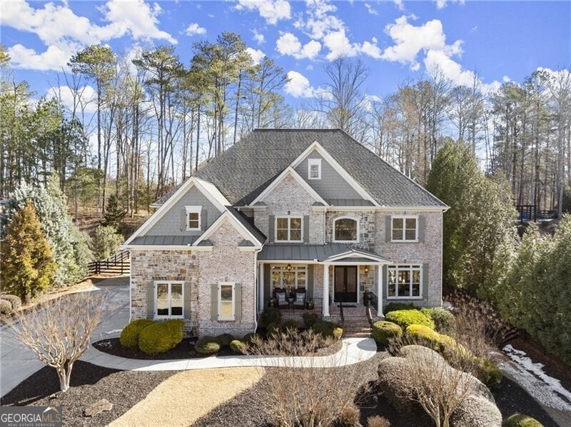 Rare opportunity in highly coveted Triple Crown! Discover the perfect blend of luxury and nature with serene lake views from your covered front porch. Hard to find main walkout saltwater pool and hot tub seamlessly connect to the heart of this single owner home, making indoor/outdoor entertaining effortless. Once inside, you are greeted by a grand two-story foyer, with a separate dining room to the left, and private, wood paneled study to the right. Natural light pours through the wall of windows in the back of this 4-sided brick and stone estate home, providing a sanctuary for relaxation, entertainment, and creating lasting memories. Bright, open concept, custom built chef's kitchen, equipped with brand new, high-end Kitchen Aid and Bosch stainless steel kitchen appliances, and hidden pantry, flows seamlessly through to the separate breakfast nook, and vaulted keeping room overlooking the private, fenced in backyard. Guests enjoy a private bedroom with en suite bathroom, in addition to a powder room and butler's pantry on the main level. Make your way up the secondary staircase to the stunning primary bedroom suite with floor to ceiling windows that frame picturesque views of the saltwater pool, while sipping a cup of coffee from your thoughtfully designed coffee bar. The oversized spa-inspired bathroom features dual vanities, custom built ins, walk in shower, soaking tub, and premium finishes. Spacious primary closet is an absolute dream! All three secondary bedrooms upstairs have their own bathrooms, and well-appointed closet spaces. Plus, a light filled media room/office/playroom rounds out the upper level. The finished terrace level combines luxury and practicality, providing endless choices for private relaxation. Featuring elegant Travertine tile, a spacious guest bedroom, full bathroom, custom bar, media room, living room with fireplace, and two additional rooms for a future gym, music room, or extra storage! Brand new carpet in bedrooms upstairs, new interior paint on all three levels, new exterior paint, only 3 year old roof. Triple Crown is districted for the trifecta of award-winning Milton public schools - Birmingham Falls Elementary, Northwestern Middle, and Milton High. Active social events for adults and children including swim, tennis, frequent ladies nights, book club, adult holiday party, Breakfast with Santa, Halloween, and more! Amazing location less than 5 minutes to downtown Milton, 10 mins to D/T Alpharetta, and less than 15 mins to Avalon & GA-400. Don't miss this unique opportunity to experience dual water views, lake in front and walkout pool in back, from the heart of Milton's equestrian country!