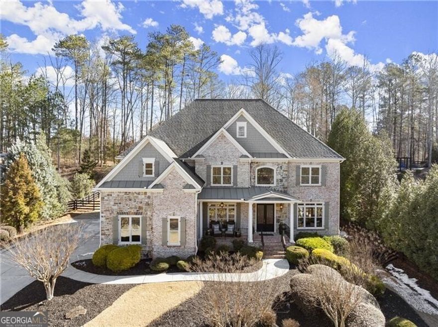 Rare opportunity in highly coveted Triple Crown! Discover the perfect blend of luxury and nature with serene lake views from your covered front porch. Hard to find main walkout saltwater pool and hot tub seamlessly connect to the heart of this single owner home, making indoor/outdoor entertaining effortless. Once inside, you are greeted by a grand two-story foyer, with a separate dining room to the left, and private, wood paneled study to the right. Natural light pours through the wall of windows in the back of this 4-sided brick and stone estate home, providing a sanctuary for relaxation, entertainment, and creating lasting memories. Bright, open concept, custom built chef's kitchen, equipped with brand new, high-end Kitchen Aid and Bosch stainless steel kitchen appliances, and hidden pantry, flows seamlessly through to the separate breakfast nook, and vaulted keeping room overlooking the private, fenced in backyard. Guests enjoy a private bedroom with en suite bathroom, in addition to a powder room and butler's pantry on the main level. Make your way up the secondary staircase to the stunning primary bedroom suite with floor to ceiling windows that frame picturesque views of the saltwater pool, while sipping a cup of coffee from your thoughtfully designed coffee bar. The oversized spa-inspired bathroom features dual vanities, custom built ins, walk in shower, soaking tub, and premium finishes. Spacious primary closet is an absolute dream! All three secondary bedrooms upstairs have their own bathrooms, and well-appointed closet spaces. Plus, a light filled media room/office/playroom rounds out the upper level. The finished terrace level combines luxury and practicality, providing endless choices for private relaxation. Featuring elegant Travertine tile, a spacious guest bedroom, full bathroom, custom bar, media room, living room with fireplace, and two additional rooms for a future gym, music room, or extra storage! Brand new carpet in bedrooms upstairs, new interior paint on all three levels, new exterior paint, only 3 year old roof. Triple Crown is districted for the trifecta of award-winning Milton public schools - Birmingham Falls Elementary, Northwestern Middle, and Milton High. Active social events for adults and children including swim, tennis, frequent ladies nights, book club, adult holiday party, Breakfast with Santa, Halloween, and more! Amazing location less than 5 minutes to downtown Milton, 10 mins to D/T Alpharetta, and less than 15 mins to Avalon & GA-400. Don't miss this unique opportunity to experience dual water views, lake in front and walkout pool in back, from the heart of Milton's equestrian country!