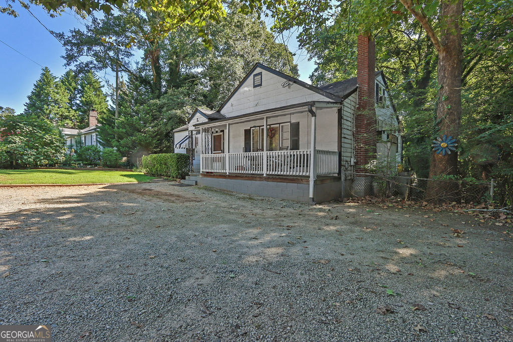 Situated within the Tucker city limits and just inside the perimeter, this charming property features a primary bedroom on the main level, plus two additional bedrooms and an office area upstairs. Sitting on almost half an acre, the home boasts a fantastic flat, fenced yard, plenty of parking for four cars in front, and a large two-story workshop in the backyard perfect for storage, projects, or hobbies. Enjoy relaxing on the inviting front porch or in the bright sunroom filled with natural light. With its prime Tucker, GA location and endless potential, this property is being sold AS IS and is ready for some cosmetic updates. Located close to Henderson Park, Historic Downtown Tucker, shopping and restaurants, CDC, Emory, and a short drive to Midtown and Downtown Atlanta. Schedule a showing today!