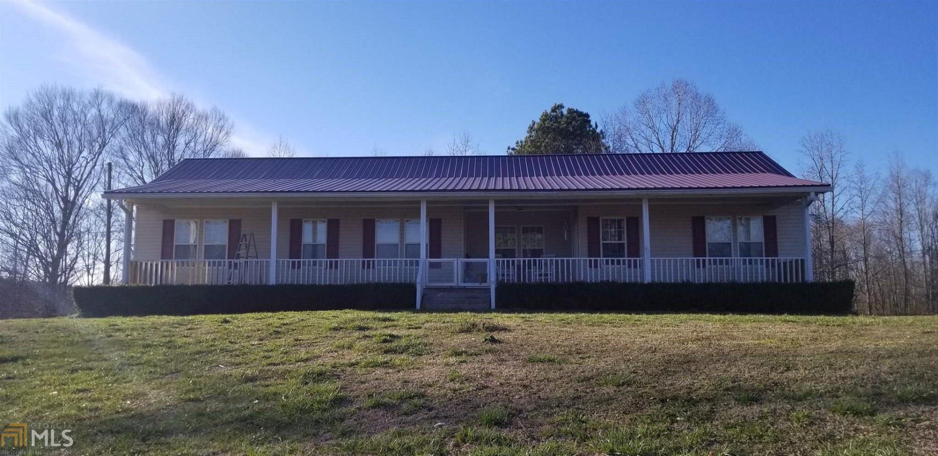It's a Wonderful World when you live in the country! Qualifies for FHA and possibly VA. This spacious 3 bedroom, 2 bath, 28 x 68 mobile home has everything you want...county water, flat ceilings, separate dining room that could be used as an office, eat in kitchen, rocking chair front porch, that goes all the way across the front of home, cozy living room that is perfect for enjoying a quiet evening in front of the fireplace with gas logs to make it even better. The outside has everything you could need on just enough land to enjoy taking care of - lots of room for a garden, several rustic storage buildings that could be he sheds or she sheds, plus an above ground pool with huge deck and canopy. Call to see!