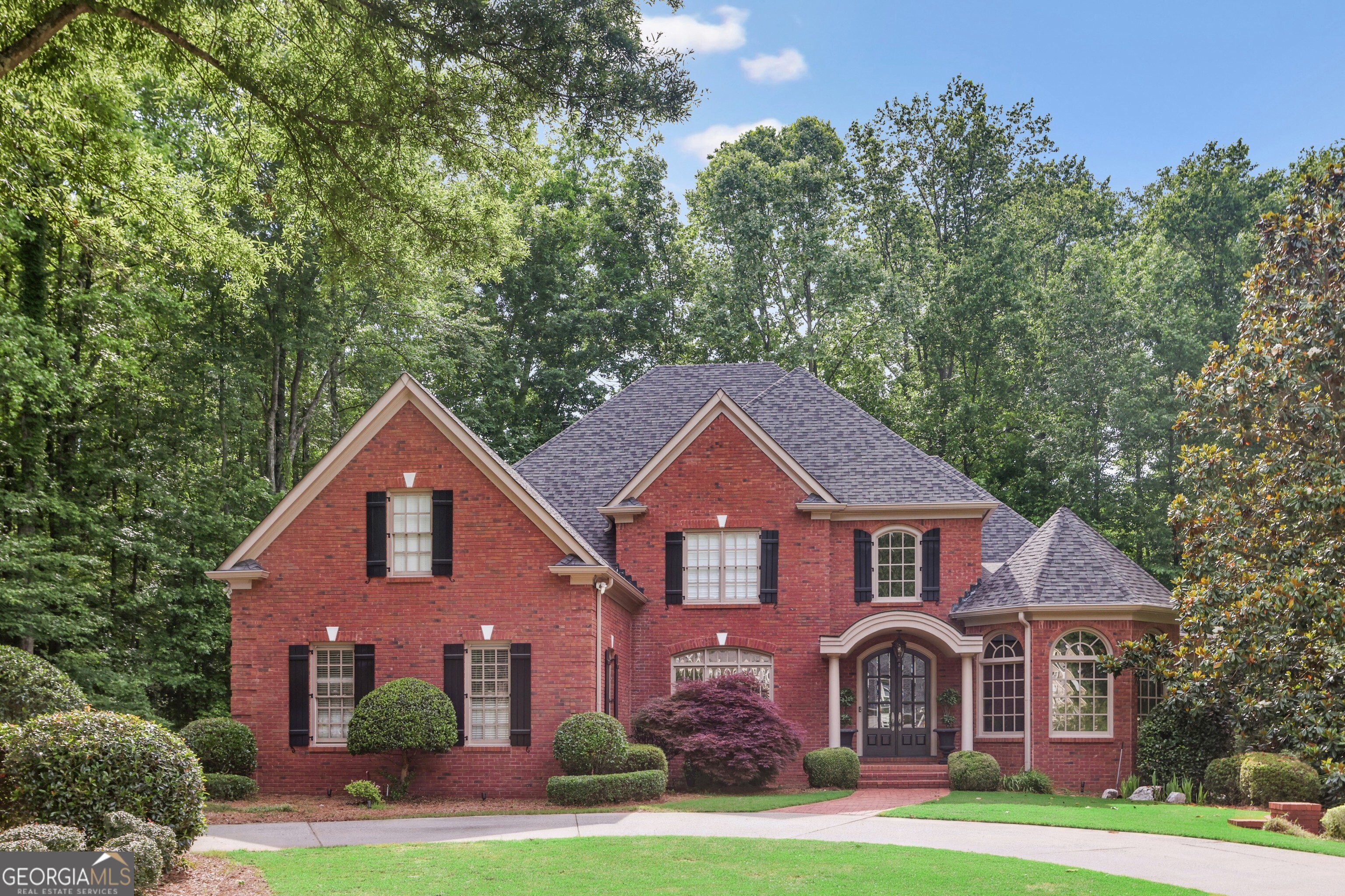 Coming Soon - A Rare Opportunity to Own an exceptional home in one of the prettiest neighborhoods and best school districts in West Cobb. This stunning four-sided brick home is situated on 1.6 acres and combines timeless elegance with superior craftsmanship. Inside, graceful arched doorways, rich hardwood floors, and custom built-ins set a refined tone throughout. Thoughtfully designed for both comfort and entertaining, the home features five spacious bedrooms and baths, including a luxurious primary suite on the main level with a spa-inspired renovated bath. The expansive terrace level offers a full kitchen, home theater, exercise room, and a private guest suite-an ideal setting for gathering with friends and family. Outdoors, enjoy serene evenings on the covered porch overlooking the sparkling pool, or cozy up by the outdoor fireplace for s'mores under the stars-all within the privacy of your own backyard retreat. Don't miss your chance to make this extraordinary home yours.