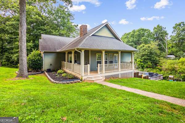 Purchase this home with no money down. If you've been dreaming of more space this tucked away 4 bed/ 3.5-bath home sitting on just over an acre of land offers both comfort and your own retreat. Walk inside and your greeted with a naturally lit open floor plan, high ceilings, large windows and a master suite that opens out to your own private back deck. Upstairs, there's a flexible loft area great for a home office, playroom, reading nook or a teen hangout. Walk downstairs to the basement with a full bath, kitchenette and bonus space. Just minutes to Hwy 365, shopping, dining, about a 20-minute drive to Gainesville, Lake Russell and outdoor trails everything you need is right within reach. Whether you're looking for room to spread out or just love a quiet retreat with space to entertain-this one checks the boxes. Come take a tour today!