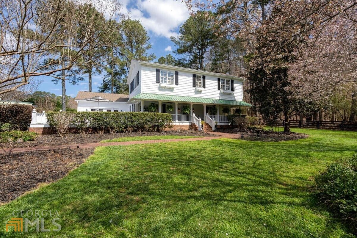 Welcome to Three Sisters Farm in Alpharetta, with Cherokee County taxes! This is the one-of-a-kind property that you have been searching for. It is a total of 2 parcels located in the Allmond Tree Farm community, with full access to Allmond Lane. It is zoned Agriculture with tax and lack of restriction benefits. Whether you are looking for an equestrian property or a family compound, this has it all. The home is an original farm house built in 1922 and fully renovated inside and out and from the foundation up, in 2003. This is a solid house. The massive stone mantle around the fireplace was harvested locally to the property. Beamed vaulted ceilings soar over the living room that is open concept with the kitchen and dining room. Hardwood flooring is laid throughout. Luxurious and well thought touches and finishes adorn this home through and through. The real gem with this farm is the outside. There are 3 outdoor relaxation and entertaining areas. Rocking chair front porch with swings and fans where you can relax and wile the summer days away looking over the lush emerald green pastures. Having more company than expected? No worries! Let the party pour out onto the adjacent open sprawling deck that is washed in the sun. Have your morning coffee on the cozy quiet patio that is tucked away off of the kitchen at the back of the house. For the horse lover, you have four board fencing around the perimeter and multiple paddocks, lush year around pastures, a run in shed and 102' x 148' M10 based riding arena. The white barn is 54' x 48' Landmark-built. It has 5 stalls, tongue and groove interior, wash rack, tack room and workroom. Not into the equestrian theme? No problem! This barn is on its own 2.47 acre parcel. Build your dream home on this parcel, convert the barn into a party barn or pool house and use the existing house as a guest house or an additional family member's house. Again, the possibilities for this property are endless. Don't miss out on owning a property with pastoral sunsetting views in Alpharetta, Cherokee. Fast easy access to Milton, Alpharetta, Roswell and Ball Ground. Top rated Creekview, Creekland and Avery school districts. Alpharetta address with Cherokee taxes!