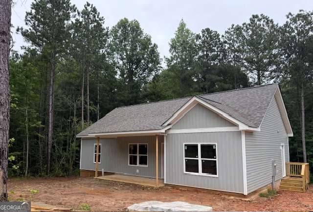 Beautiful Ranch Style Home on 3.1 Wooded Acres!! No HOA! Enjoy peaceful country living in this gorgeous 3 bedroom, 2 bath ranch home set on a private, wooded 3.1 +- acre lot. With No HOA and not in a subdivision, you'll have the freedom to make this home truly your own. Step inside to an open concept layout featuring a vaulted ceiling in the living room and the dining room! The kitchen features stainless steel appliances, a breakfast bar, pantry, and granite countertops! Convenient main level laundry room makes daily living a breeze! The master suite boasts a tray ceiling and master bath with a double vanity plus an oversized tiled stand-up shower. With split-bedroom style for added privacy, the two additional bedrooms and full bath provide ample space for family or guests. You can also look forward to relaxing on the covered back porch and take in the beauty of your wooded surroundings. This home combines comfort, style and privacy! Perfect for those seeking a serene country setting while staying close to modern conveniences. Approximate completion date is 45 days from contract date!