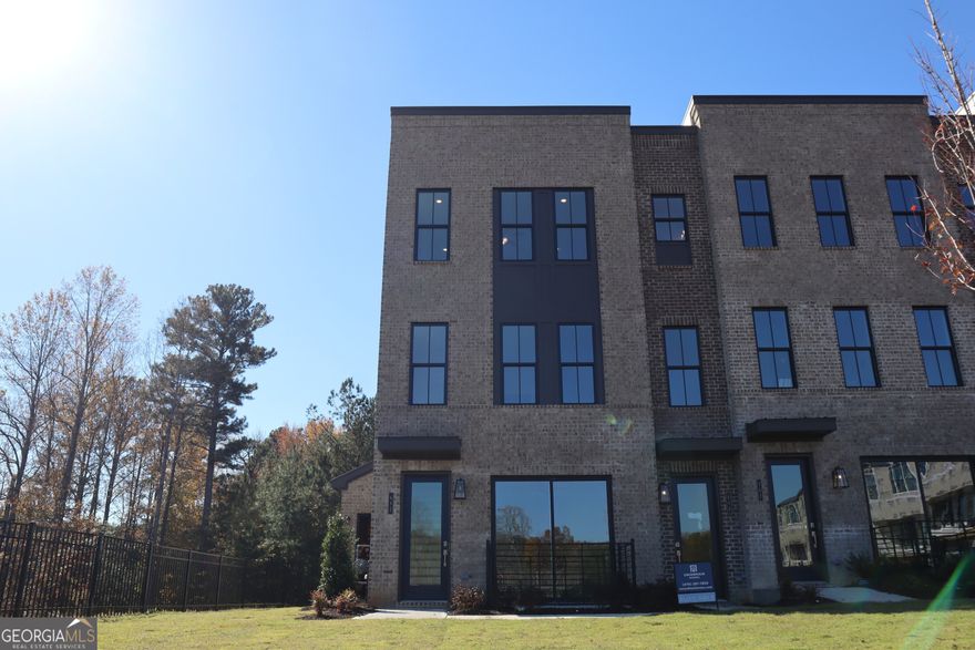 Brand-New Condo - Never Lived In! Discover modern living in this pristine end-unit condo, ideally situated in the heart of Suwanee and just minutes from Suwanee Town Center. Surrounded by lush green space, this premium lot offers privacy, a prime location, and access to top-rated schools.    Spanning 1,071 sq.ft., this two-story home features 2 spacious bedrooms and 2.5 baths, with luxury vinyl plank (LVP) flooring throughout for a sleek, low-maintenance finish. Entertain in the gourmet kitchen, complete with stylish finishes and modern appliances. A dedicated garage adds convenience and peace of mind.    This is the perfect blend of comfort, style, and location-ready for you to move in and make it your own.