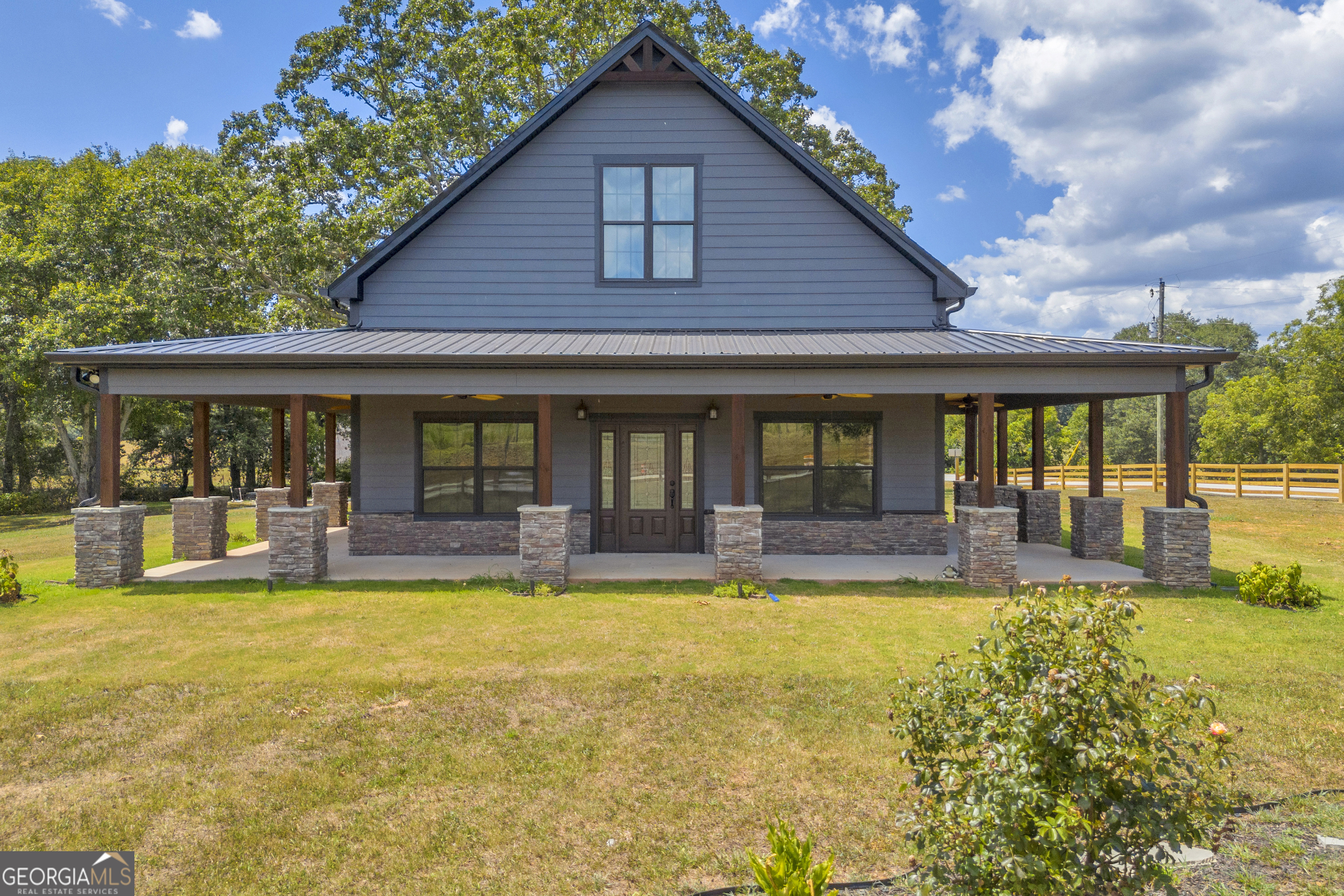 Welcome to your Custom-Stick Built Beauty in the Heart of Danielsville! Located at 6724 Highway 174 - a nearly-new, custom-built gem that blends craftsmanship, space, and comfort on just over an acre of fully fenced lot. Built in 2023, this stunning 1,900 sq ft home offers thoughtful design from top to bottom, including high ceilings, gorgeous wood accents, and landscape lighting that makes the home shine day or night. Inside, you'll find two spacious master suites, perfect for multi-generational living or hosting guests in style. The oversized kitchen is a true showstopper - ideal for cooking, gathering, and making memories. An additional room offers flexibility as a third bedroom, office, or hobby space, and the well-placed half bath off the laundry room adds everyday convenience. Outside, enjoy privacy and functionality with a fully fenced lot and dual gated entrances, offering peace of mind and plenty of room to roam. With all the benefits of new construction and the warmth of custom finishes, this home is move-in ready and packed with charm. Conveniently located just 25 minutes to Athens, 20 minutes to Commerce, and 15 minutes to Royston, you'll enjoy peaceful country living with quick access to shopping, dining, and major highways.Seller is offering $10000 incentive! Take advantage of this incredible opportunity in incentives with an acceptable offer! Use it to cover your closing costs, reduce your interest rate, or put it toward building a carport or detached garage. You choose how to make this home your own!The possibilities are yours, let this bonus bring your vision to life!Don't miss your chance to own this thoughtfully designed home in beautiful Danielsville - schedule your showing today!