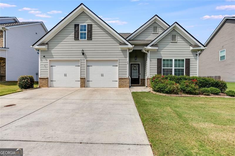 Welcome to this beautifully maintained single-story home that blends comfort, style and convenience. From the moment you arrive, the home's curb appeal sets the tone with its manicured landscaping, dual garage with auto openers and charming front entry. Inside the home opens to a bright and welcoming foyer with crisp trim work and durable flooring that flows seamlessly throughout the main living areas. A versatile front room offers the perfect space for a guest bedroom, office or hobby room, filled with natural light through large windows. The open-concept layout makes everyday living and entertaining effortless. The dining room features elegant coffered ceilings and room for gathering. The spacious living room centers around a cozy fireplace, ideal for relaxing evenings and connects easily to the modern kitchen. Here you'll find upgraded stainless appliances, granite countertops and a bar with extra seating and cabinets that makes this space as functional as it is attractive. The primary suite is a peaceful retreat with tray ceilings, ample space for larger furniture and an ensuite bath that feels spa-like with its double vanity, full wall mirror, tiled walk-in shower with seating and generous walk-in closet space. Secondary bedrooms and bathroom are thoughtfully designed, ensuring both comfort and privacy in the spacious accomodations. Every detail of the home has been cared for, making it move in ready. Step outside into the fenced backyard where there is room for pets, play or a nice garden. The extended concrete patio allows space for enjoying a cookout or s'mores under the stars. The wood privacy fence encloses the whole back yard allowing for privacy and double gates allow access on both sides of the home. It is important to note that the two attached TV's and camera system are staying in the home as well as the refrigerator, washer and dryer. The community offers a clubhouse, inground pool and playground and is just minutes from shopping, schools, medical facilities and I-75 makes this a prime location