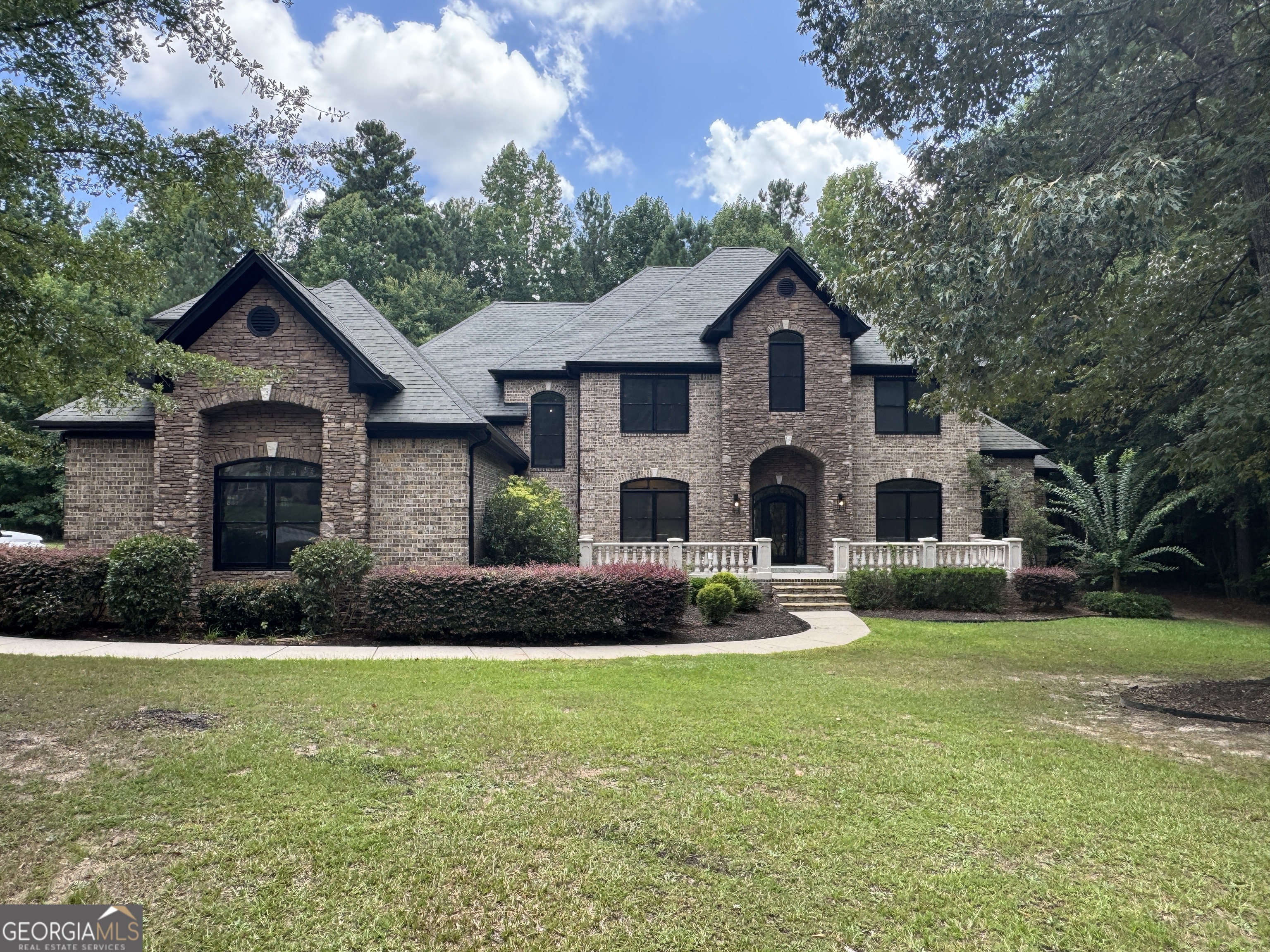 Stunning Two-Story Brick & Stone Home in a Sought-After Community with Resort-Style Amenities. Welcome to this beautifully crafted two-story brick and stone residence, nestled in one of the area's most desirable communities featuring exclusive access to a sparkling pool, clubhouse, playground, and more. Step inside to an impressive open floor plan with soaring ceilings and natural light that floods the space, creating a warm and inviting atmosphere. The main level is designed for both comfort and functionality, featuring a spacious primary suite complete with a sitting area, cozy fireplace, and a luxurious en-suite bath-a perfect retreat at the end of the day. Also on the main level, you'll find a private home office, ideal for remote work, and a guest bedroom with access to a full bath-perfect for visitors or multigenerational living. Upstairs offers plenty of room to grow with three generously sized bedrooms, a large bonus room, and a flex space that can be customized as a playroom, home gym, craft area, or media room. Whether you're entertaining or enjoying a quiet evening at home, this residence offers the ideal blend of elegance, space, and modern living-all within a vibrant, amenity-rich community.