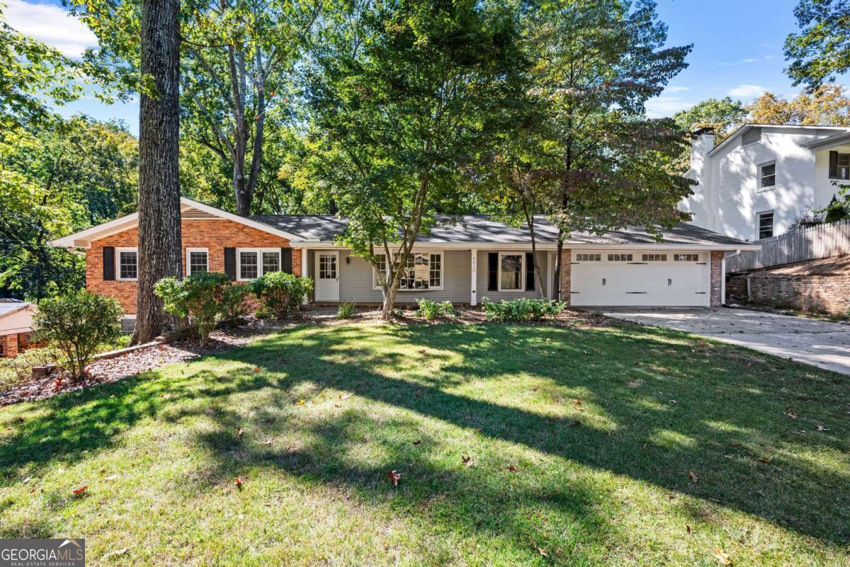 Set on nearly half an acre in the heart of Sandy Springs, this 2,900-square-foot ranch with a finished terrace level offers an exceptional blend of space, function, and location. The main level spans approximately 1,900 square feet and features an open, light-filled layout with a large living and dining area that flows effortlessly into an inviting kitchen with bay-window views of the backyard and a casual breakfast nook. Three well-sized bedrooms and two full baths provide comfortable accommodations, with thoughtful details and natural light throughout. The fully finished terrace level adds another 1,000 square feet of impressive living space, complete with new luxury vinyl flooring, fresh paint, and a flexible open layout ideal for entertaining, a media room, or recreation. A spacious office with windows, a private guest suite with a full bath, and an additional exercise or hobby room with exterior access make this level as functional as it is inviting. Outside, the home's curb appeal is enhanced by a recently added two-car garage, a wide front yard, and a private backyard with a generous deck perfect for outdoor dining or relaxation. Located in one of Sandy Springs' most desirable and walkable neighborhoods, this property offers effortless access to nearby shops, restaurants, and parks - the ideal balance of space, setting, and convenience.
