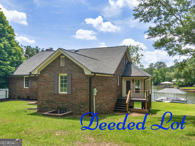 Let's Talk... HOME SWEET HOME ON JACKSON LAKE! Solid Brick Beauty on .57 Acre DEEDED lot. And you'll have your own Boat Ramp! Fabulous big water view and 134 feet of shoreline plus Covered Dock and Boat Lift. This property is an Entertainer's Delight with the large party room, bath and kitchenette on the lower level that leads to a flat yard with beautiful St. Augustine grass for friends and family fun. The kids will love the playroom in the cool Loft overlooking the Dining area and great room. The large kitchen has a long breakfast bar and plenty of pantry and storage space. Be sure to see the super Sunroom & Covered Deck with gorgeous lake views for relaxing coffee and tea times. Each comfortable bedroom has a private bath and large closet. This interior is low maintenance with the brick and cedar never needing painting. Take a Sunday Drive and Come to the Lake! For more details...Talk to Tammy!