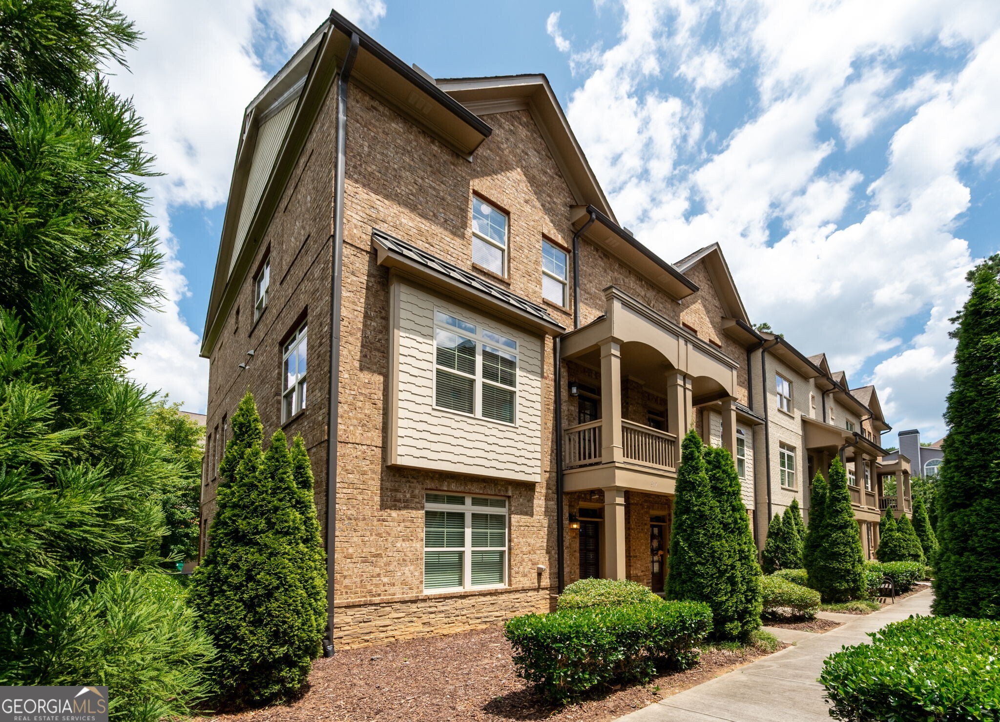 Welcome to your dream townhome, perfectly nestled in a vibrant community moments away from The Battery/Truist Park with easy access to I-75 & I-285, this prime location makes commuting a breeze while also providing an array of shopping & dining options right at your fingertips. The beautifully appointed kitchen features granite countertops, stainless steel appliances and a spacious island. The kitchen is open to the cozy family room complete with fireplace flanked by floating shelves and coffered ceiling. There is also a separate dining room providing a refined space for meals with family & friends. Retreat to the spacious primary suite featuring a walk-in closet and bathroom with granite finishes & separate tub/shower. Two additional bedrooms and bathroom provide comfort & privacy for family or guests. The lower level boasts a convenient guest suite complete with private bath for visitors or as a home office. Enjoy the convenience of the rear-entry 2-car garage. Don't miss your chance to make this stunning townhome your new home!