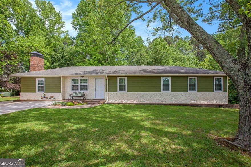 Welcome to 3852 Drew Campground Rd-an incredible 4-bedroom ranch nestled on over 2.5 private acres in Cumming. This home is packed with character, featuring stylish updates, a cozy brick fireplace, and a vibrant kitchen that brings charm and personality to every meal. Step out onto the oversized covered deck and enjoy the peaceful, wooded surroundings.    What truly sets this property apart is its functionality for small business owners or hobbyists. A massive industrial shop with underground power provides the ultimate setup for storing equipment, running a business, or creating the ultimate workshop. Additional sheds and storage buildings on the property offer even more flexibility and space to grow.    Whether you want to live where you work, or work where you live, this property gives you the freedom to do both-comfortably and efficiently.