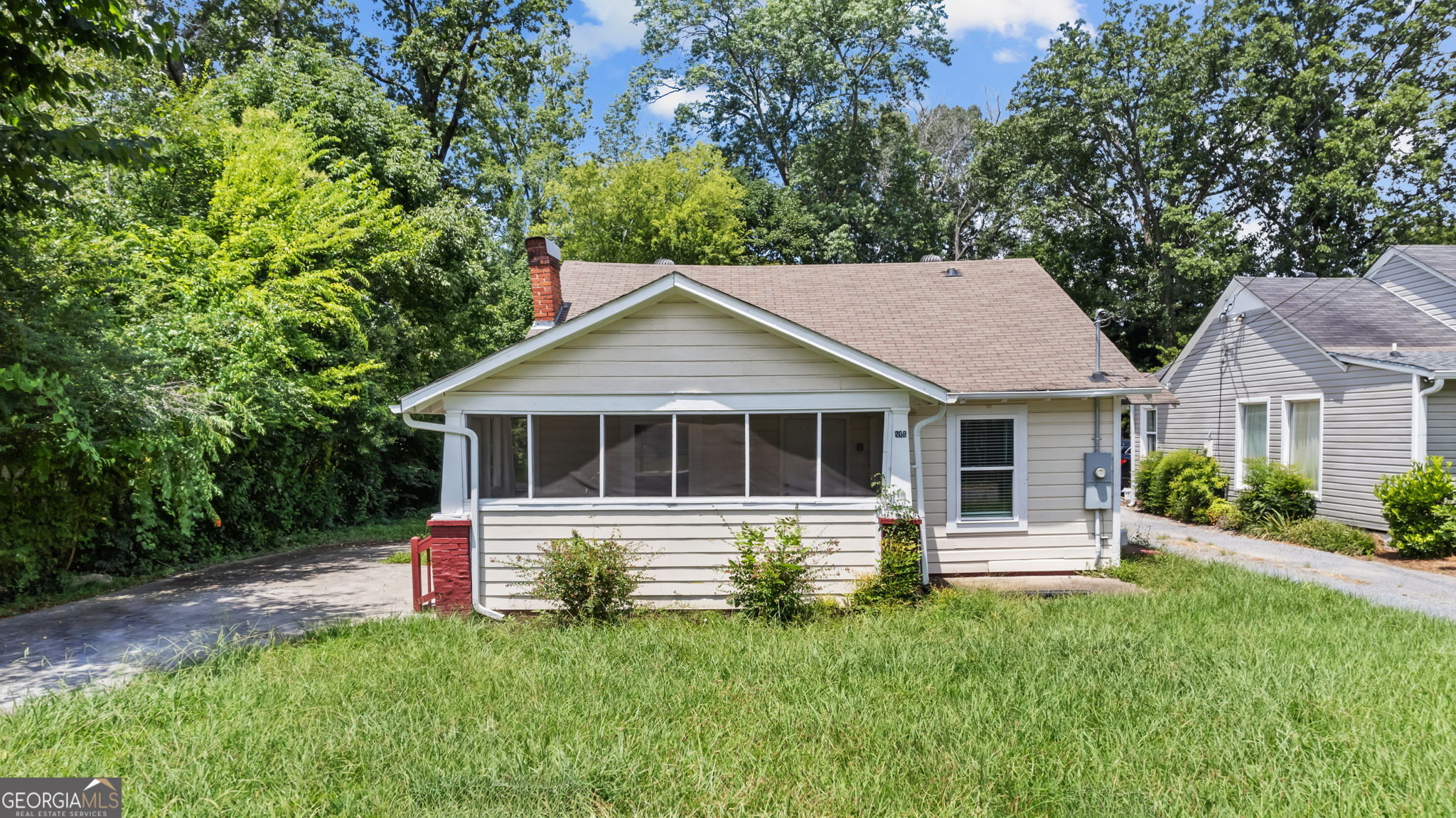 Don't miss this opportunity to own this charming intown home with both character and updates! This spacious bungalow offers the perfect blend of historic charm and modern convenience. Step onto the relaxing screened front porch and into a warm, inviting space featuring refinished hardwood floors, an arched doorway, and a decorative fireplace. The updated vinyl windows and modern lighting enhance the home's appeal while maintaining its timeless character. The kitchen boasts crisp white cabinetry, a double sink, and plenty of space. Enjoy the convenience of a separate laundry room, paved driveway, and a level yard ideal for outdoor activities. A front patio provides additional space to relax and unwind. With 2 full bathrooms, this home will not last long!