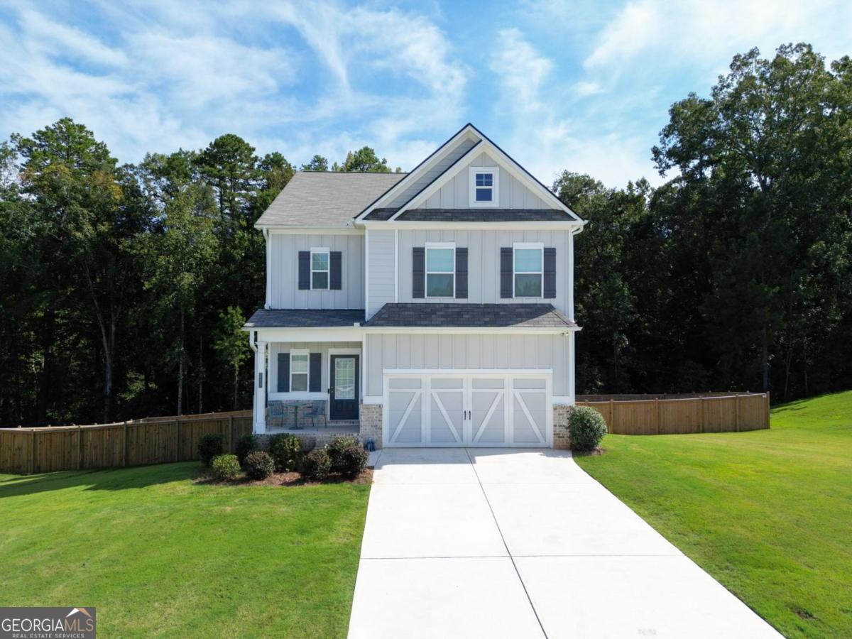Wake up to sunlight pouring through large, picturesque windows and savor your morning coffee on the deck overlooking your fenced backyard and half-acre lot, with plenty of space between you and the next home. This Cynthia floor plan in Laurel Cove, just minutes from the new Jackson County High School, is designed for living, entertaining, and making memories. The main level flows effortlessly with wide plank laminate flooring and a kitchen that's both beautiful and functional, featuring white cabinetry, a large island, herringbone backsplash, and stainless steel appliances. A guest bathroom adds convenience, while the full daylight basement, already stubbed for a bath, is ready for a home gym, media room, or play space. Upstairs, the primary suite is a peaceful retreat with a tray ceiling, walk-in closet, and spa-style bath with soaking tub and separate shower. Three additional bedrooms, including one with its own bath, an office nook, and laundry complete the upper level, giving space for family, guests, and everyday life. From quiet mornings on the deck to lively dinners in the kitchen, this home combines space, style, and warmth in every corner.