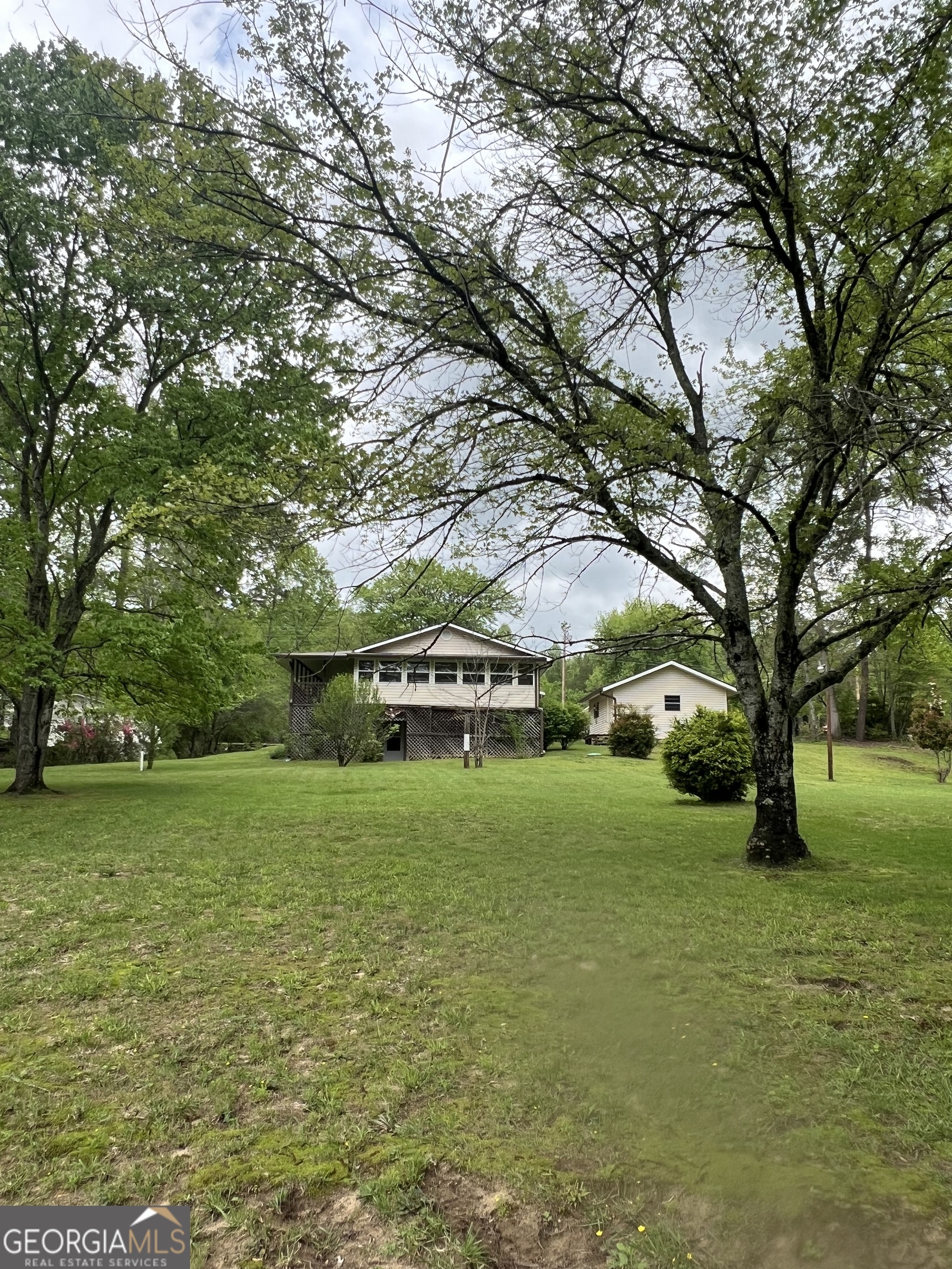 A 4 bedroom & 2 Bath lovely home located with beautiful Hemptown Creek frontage that's width of acreage. This home & creek will provide hours of relaxation , wading or swimming from the huge manicured grounds where one can enjoy the backyard or spend the day catching Rainbow, Brown, & Brook Trout that this famous creek is known for. Living room has a gorgeous stone fireplace, plus CHA. Step-saver light and cheerful kitchen comes with appliances & walnut wood cabinets. Separate dining area . Established grounds w/ flowering bushes & gorgeous shade trees. Detached garage w/ separate workshop . Large covered porch off living room & an enclosed sun porch /den/office to enjoy creek sounds from either of the 2 master suite bedrooms on the main level. Lower level has 2 bedrooms with outside entrance & an abundance of storage space . Basement level also has unfinished rooms for a potential kitchen area, liv. rm. area etc. This house is comfortable & well maintained with newer features throughout.