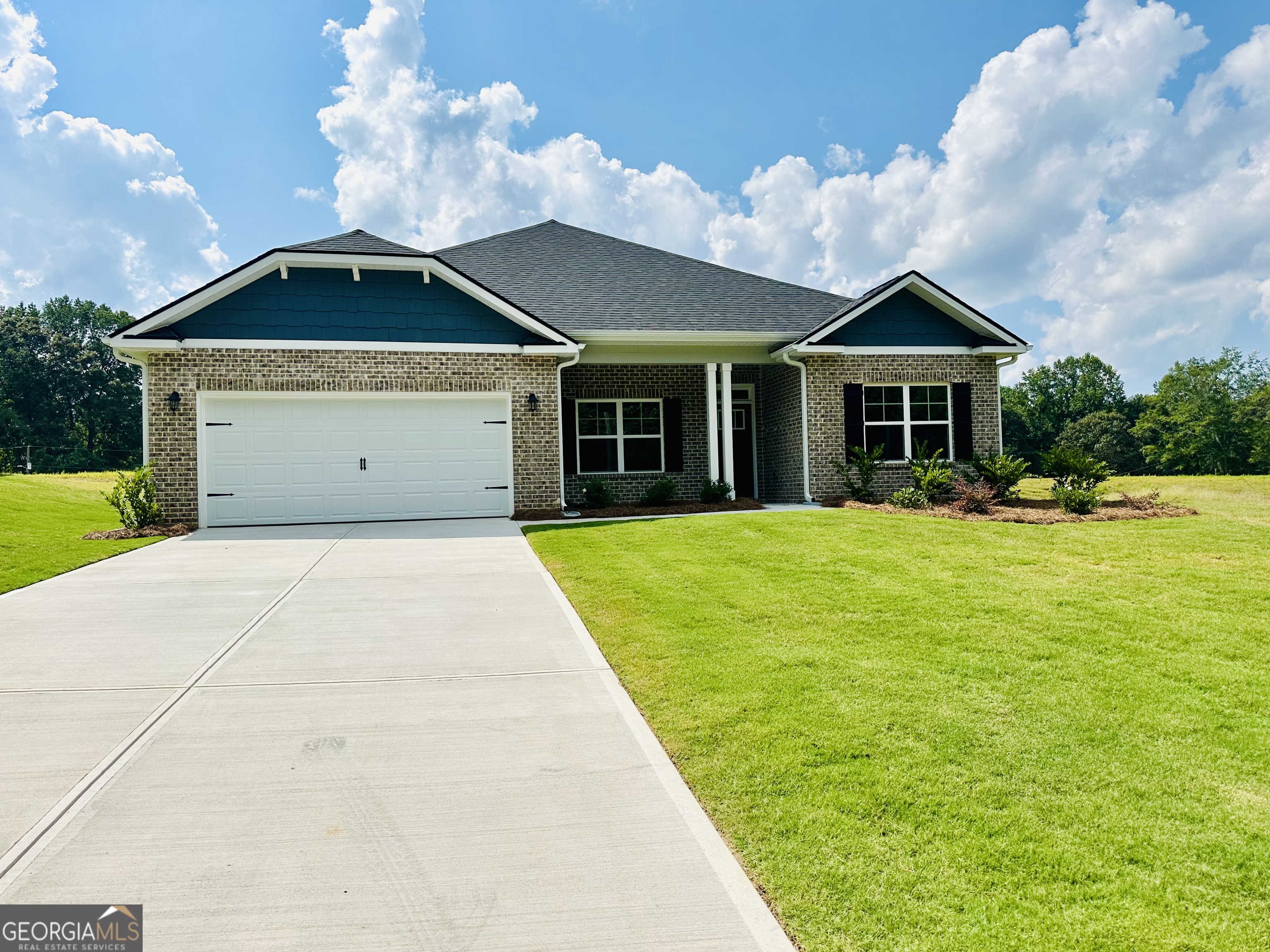 Welcome to this "Park Place Sanctuary" - Charming and Modern 4 Bedroom / 2 Bed - Ranch Retreat in the Park Place community! Envision waking up in your 2100 sq. ft. dream home in Park Place, affectionately known as "The Friendly City", Bowdon, GA. Designed to last and crafted with care, this home blends cozy nooks with open gathering spaces, inviting laughter, stories, and Sunday dinners. Natural light fills the walk-in foyer and spacious dining room leading into the great open-concept family room, with a gorgeous granite countertop island awaiting your gourmet meal prep and a pantry just waiting to be filled. This beautiful split-bedroom layout offers 2 spacious secondary bedrooms and a full bath as you walk into the hallway. The amazing owner's suite has a luxurious soaking tub, a separate shower, and a walk-in closet. This thoughtfully designed space offers both privacy and connection, creating the perfect atmosphere for modern living. Home features 1 additional bedroom that may be suitable for an office / study. Picture yourself unwinding on your covered lanai, overlooking a peaceful and spacious backyard for outdoor living and family barbeques. Whether hosting lively gatherings or enjoying a quiet evening, this home is designed to enhance every moment of your life. Built for quality and efficiency, "The Park Place Sanctuary" features architectural shingles for durability and two water heaters to ensure lasting comfort and peace of mind. You'll enjoy natural light throughout the day, making every room feel warm and inviting. Situated in Carroll County, minutes from I-20, local Bowdon schools, Tanner hospitals, the University of West Georgia, and West Georgia Technical College. Along Georgia State Routes 100 and 166, Bowdon combines small-town charm with convenient access to nearby communities, local downtown restaurants, and boutique shops. Near Carrollton Greenbelt walking trails, Little Tallapoosa, Hays Mills, and John Tanner Parks - great for outdoor life, hiking, biking, walking, boating, and fishing. USDA financing eligibility, and only $1,000 in earnest money required, making homeownership affordable and attainable. This is your opportunity to own a residence that perfectly blends style, efficiency, and affordability. Schedule your private tour today and start making memories within the "Park Place Sanctuary."